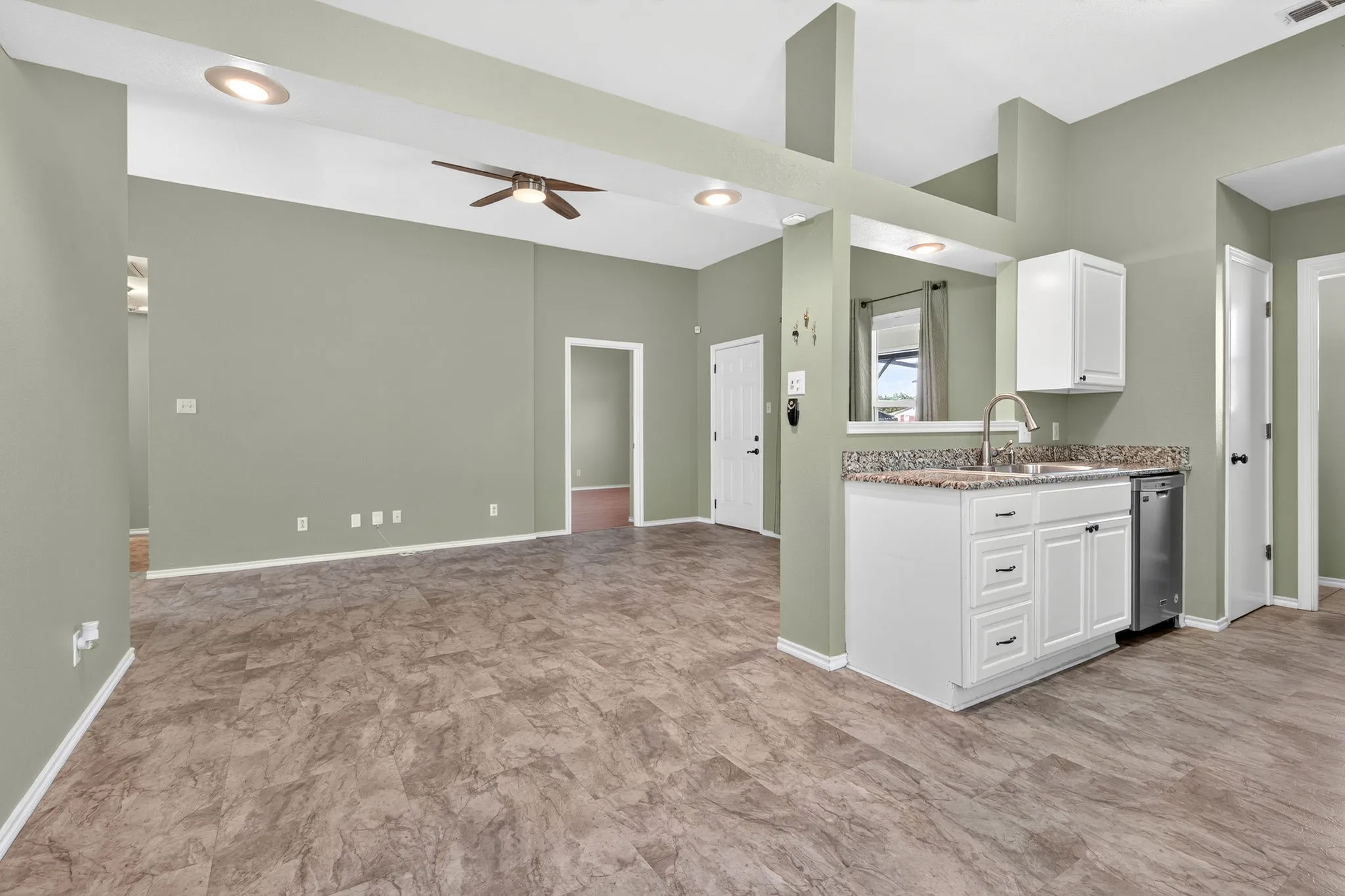 Open-concept dining area with view of living area, recessed lighting, and kitchen.