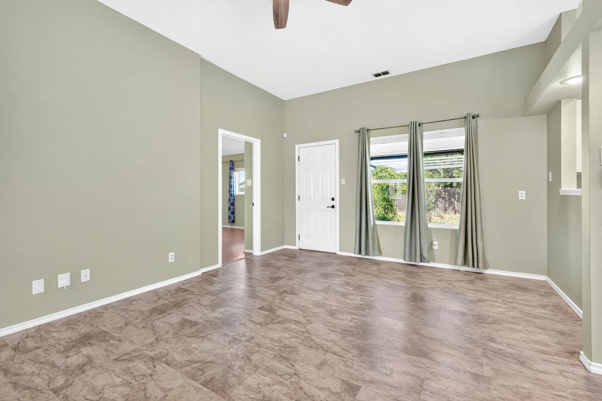 Light and airy living with double windows adjacent to primary suite.
