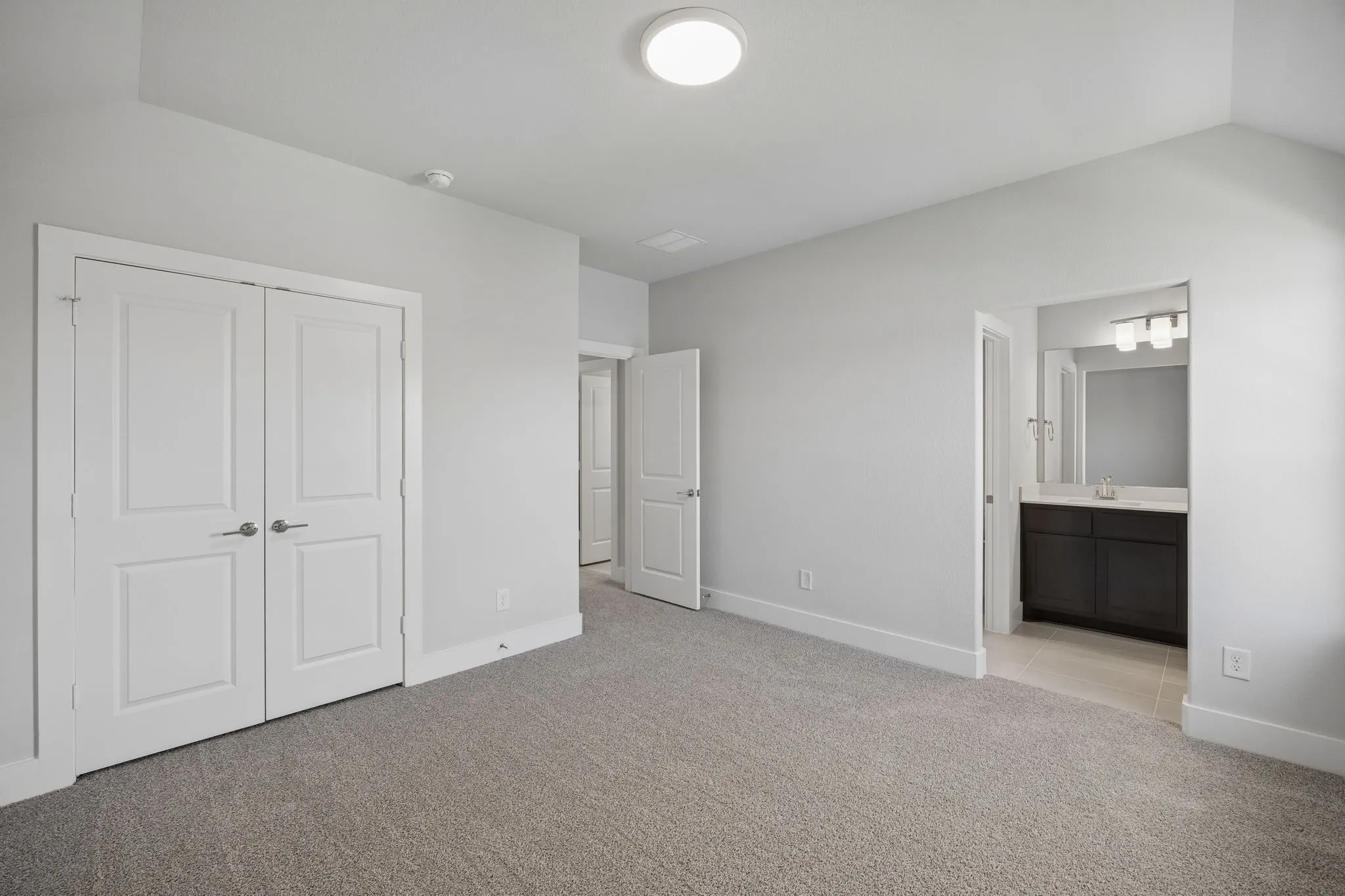 Wall-to-wall carpeting and white trim throughout