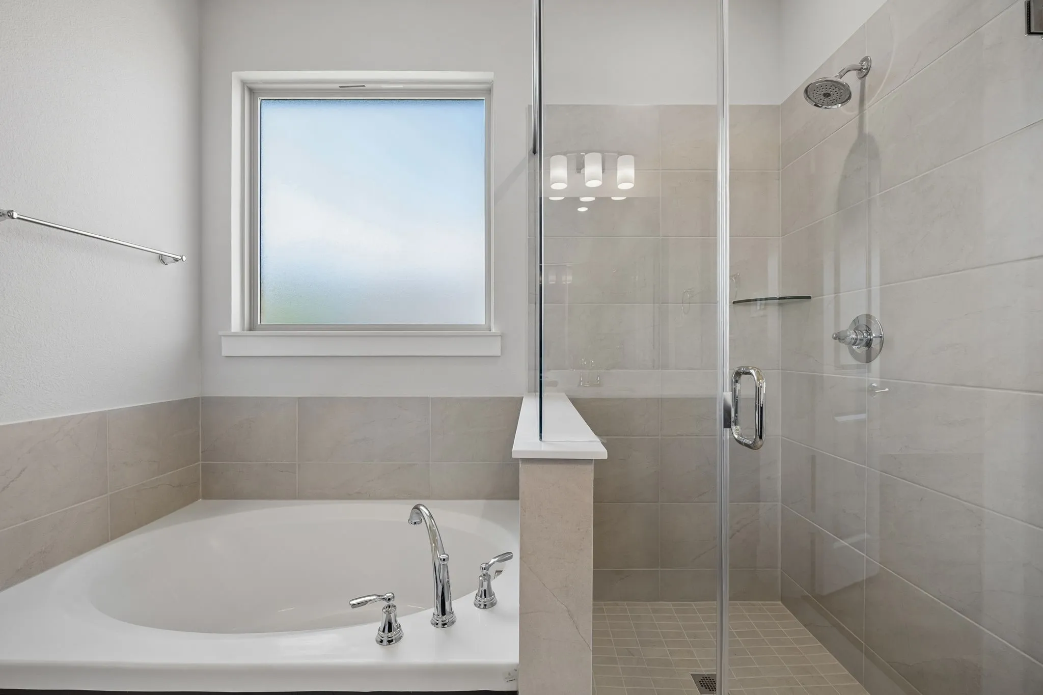 Soaking tub with polished chrome fixtures and a privacy window