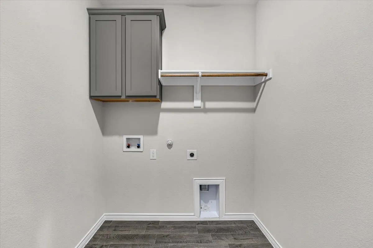 Laundry room with cabinet storage and shelving