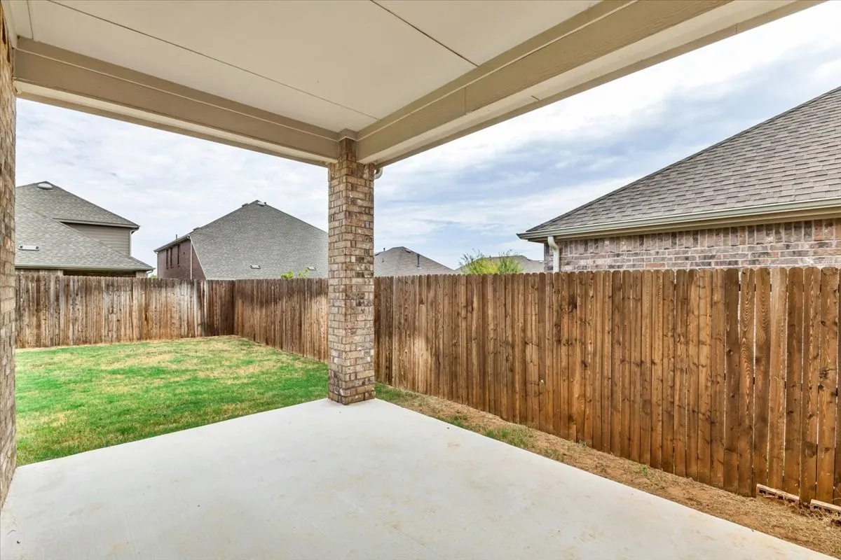 Large covered rear patio is ready for summer grilling and activities