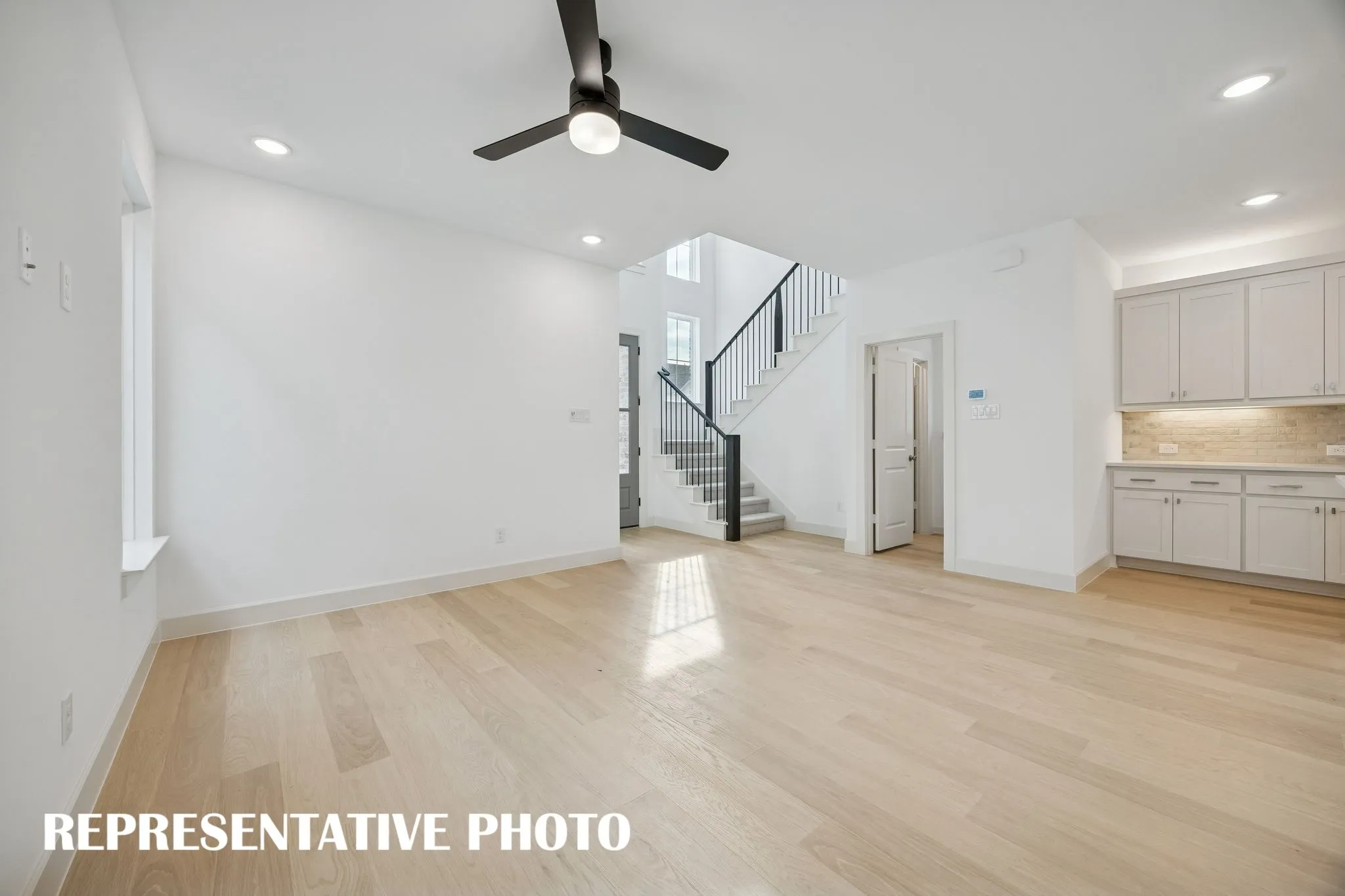 Your new family room offers lovely flooring with plenty of windows to fill the space with natural light.  REPRESENTATIVE PHOTO