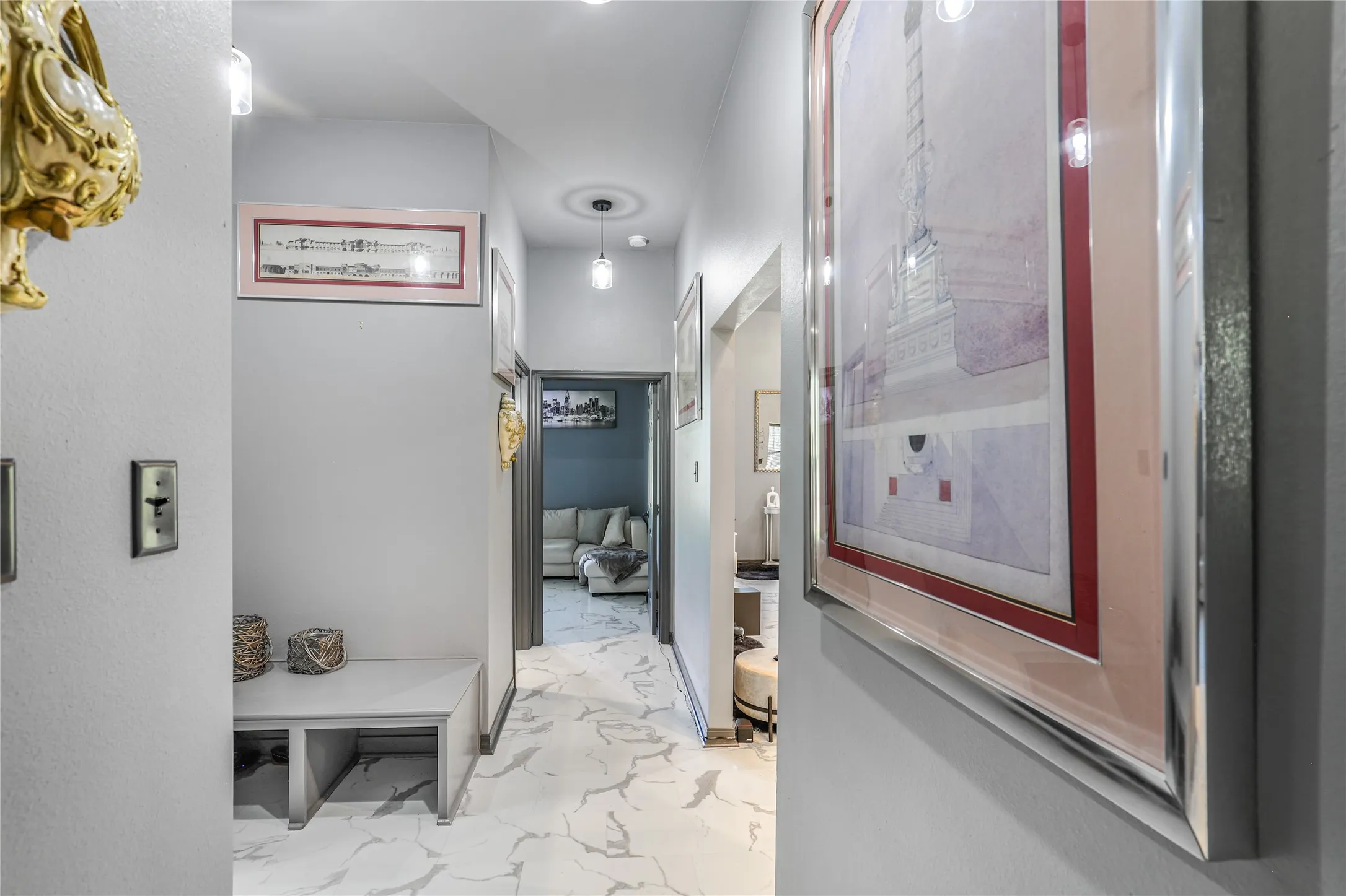 Hallway with recessed lighting, pendant lighting, and white tile flooring