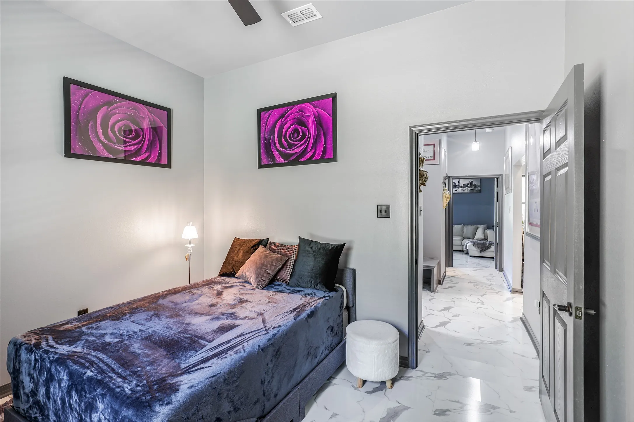 Recessed lighting, ceiling fan, white marble-style flooring, and a gray painted interior door