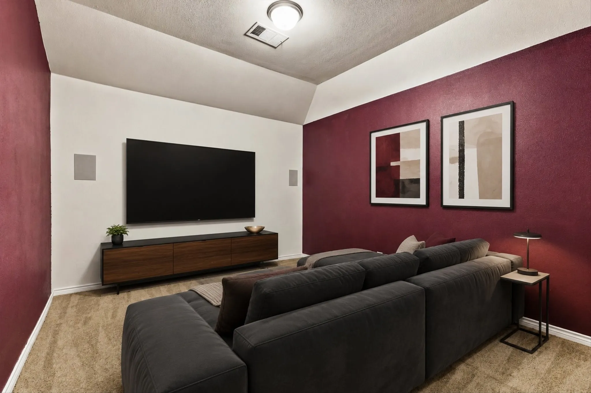 Room featuring two-tone wall treatment, built-in wall speakers, and recessed ceiling lighting