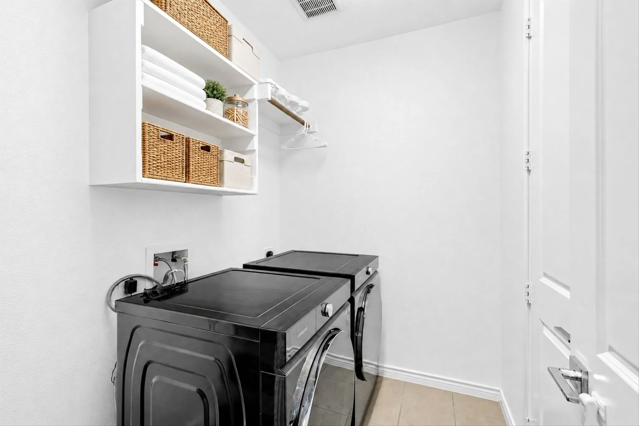White wall-mounted shelving with integrated hanging rod