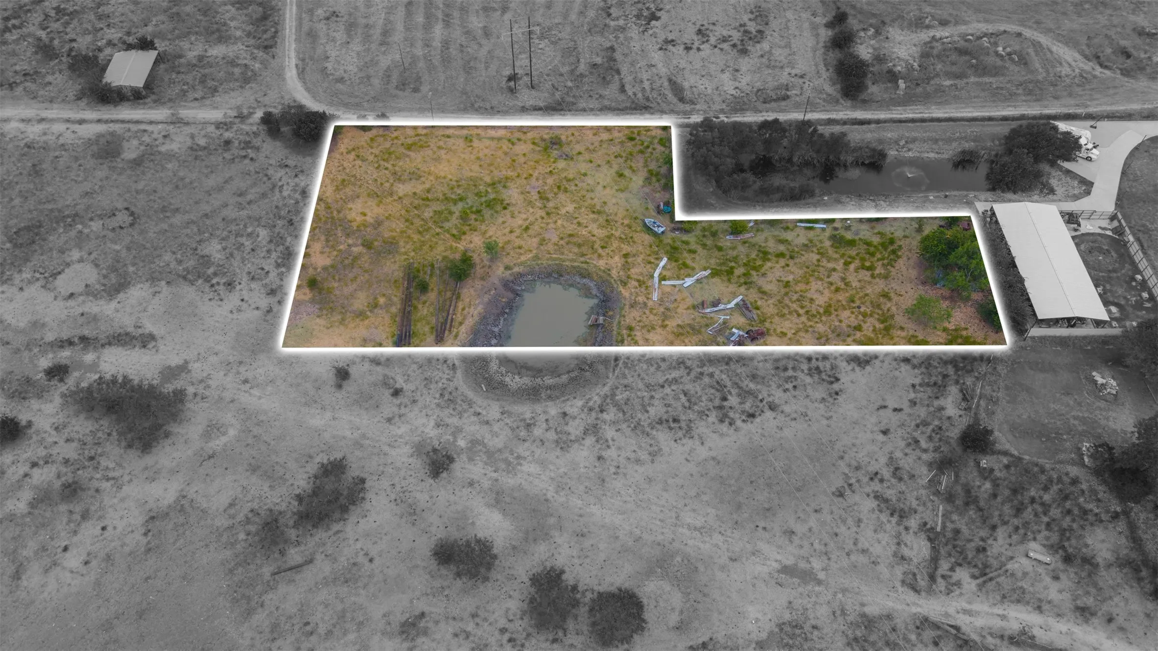 Expansive land parcel featuring a natural pond and varied topography