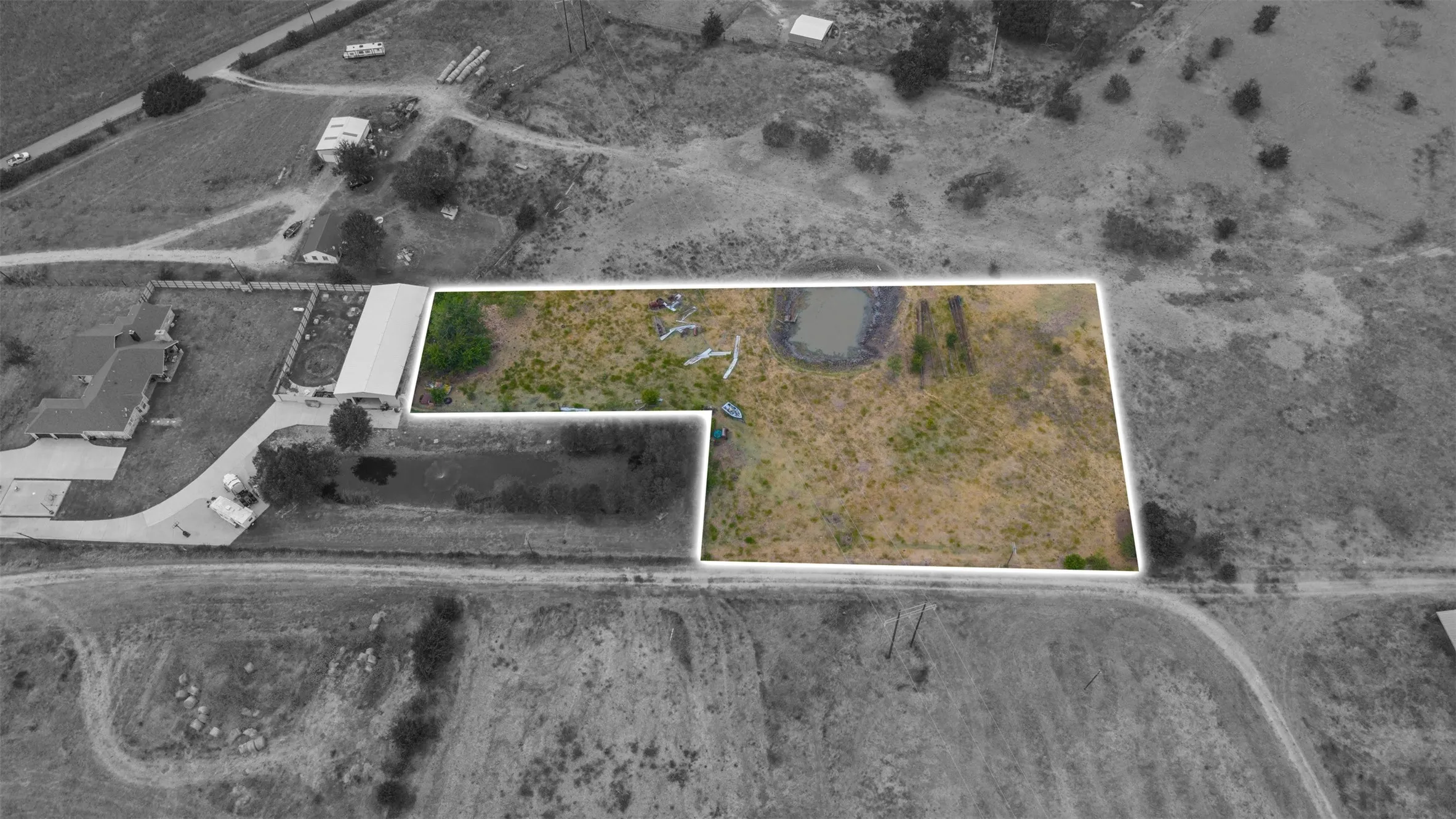 Expansive land parcel featuring natural terrain and a visible pond