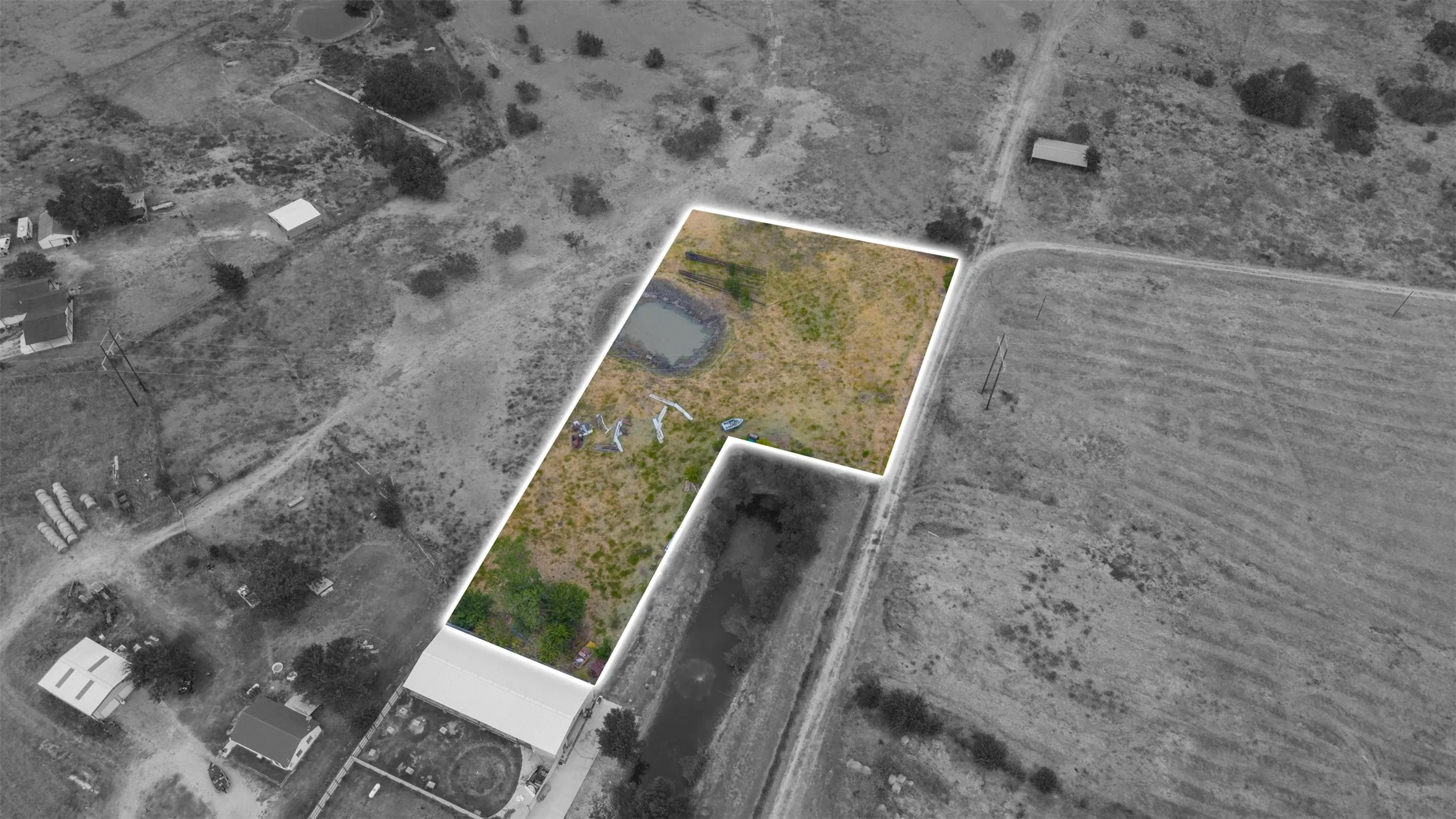 Expansive land parcel featuring a natural pond and varied topography