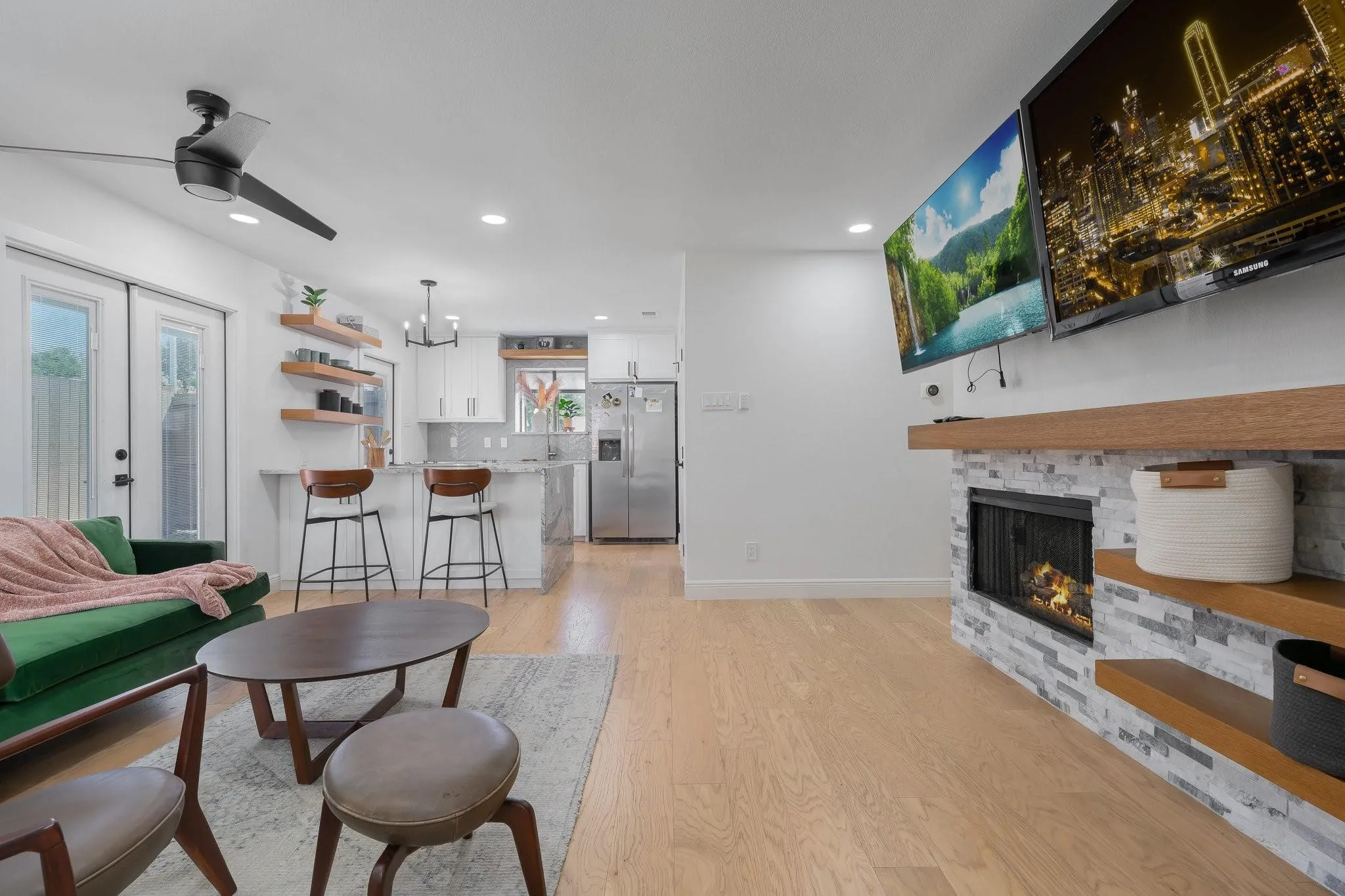 Living area with wood-finish flooring, a contemporary ceiling fan, and recessed lighting