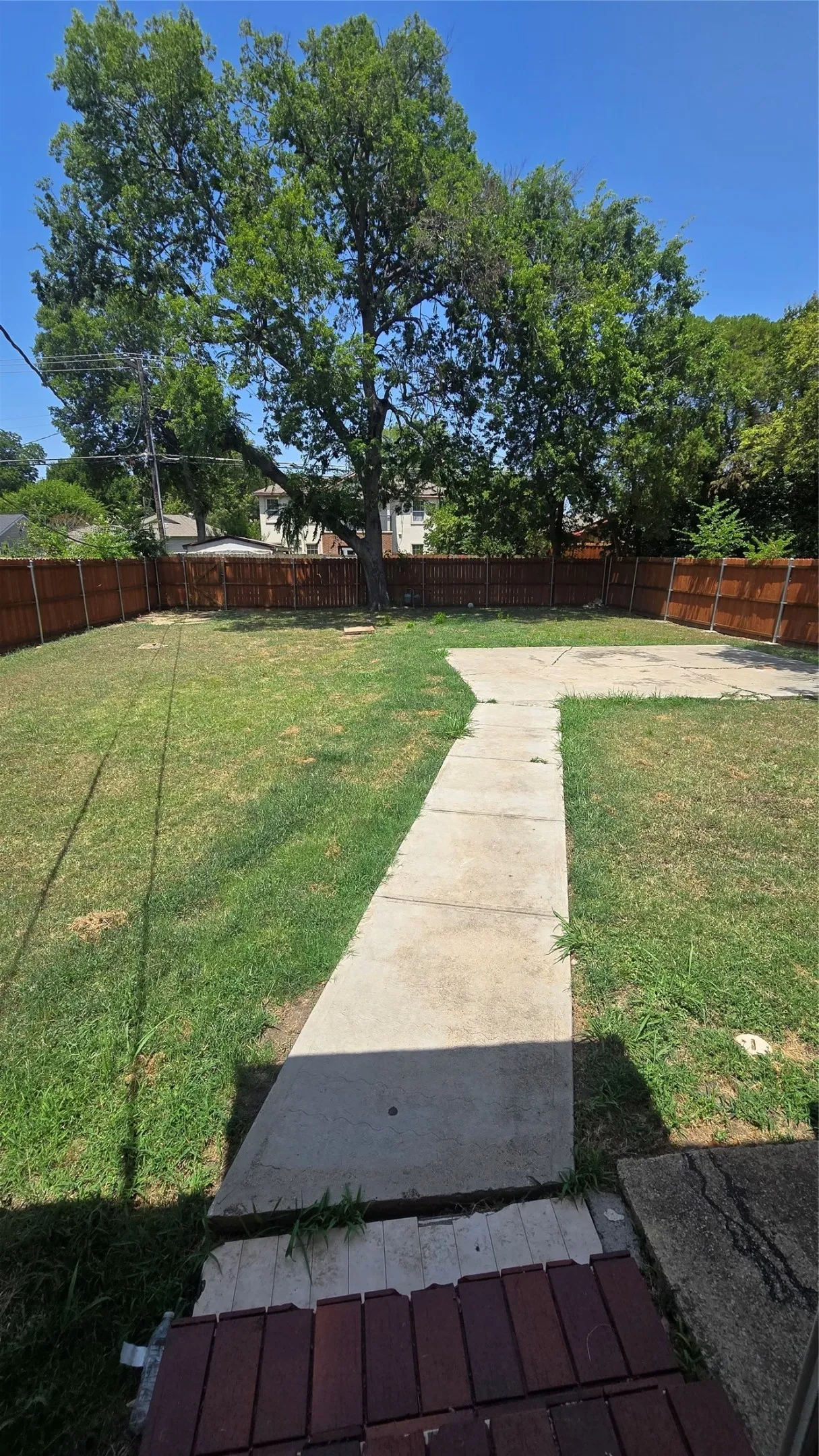 Huge backyard with concrete patio area