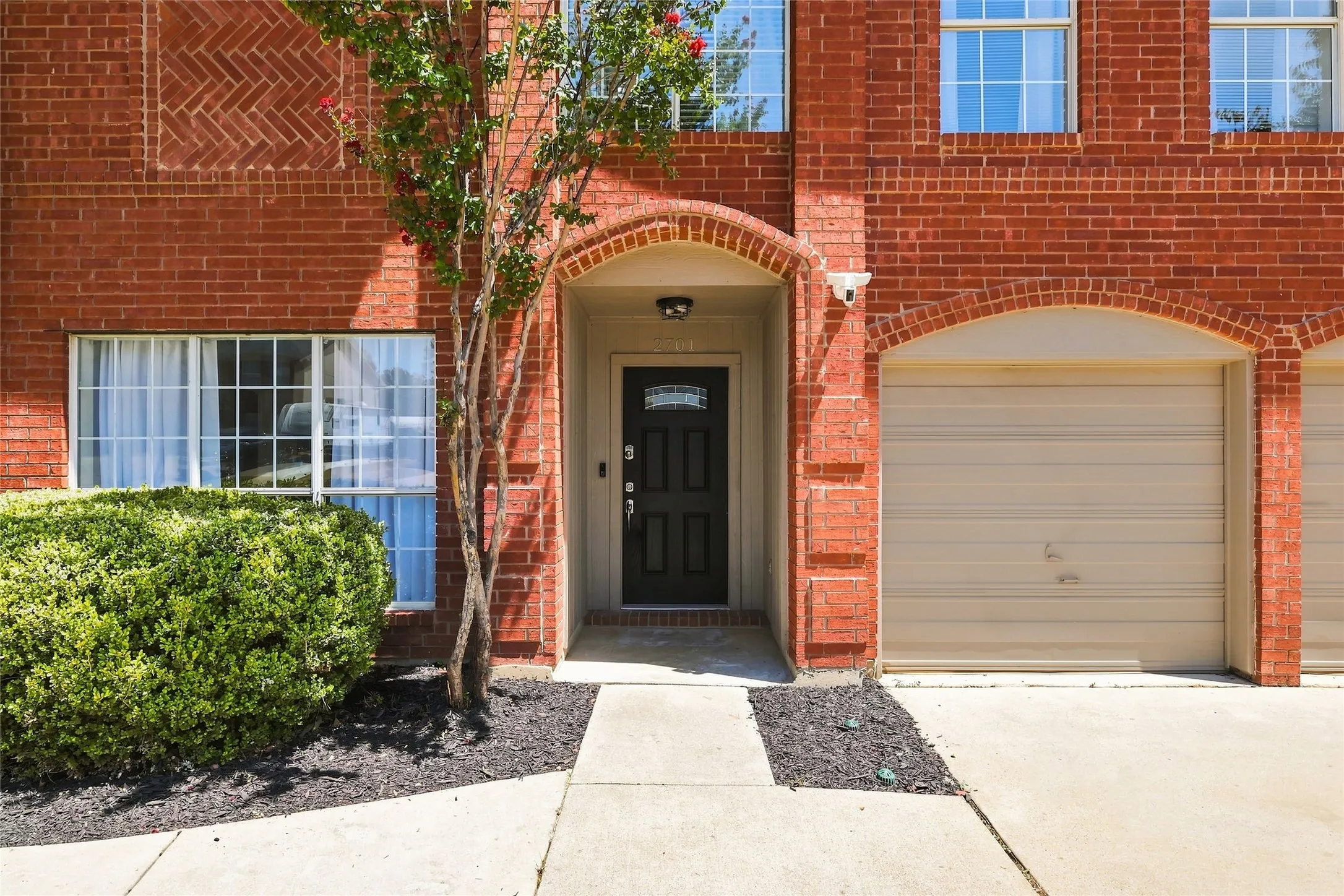 Red brick exterior with arched entryway