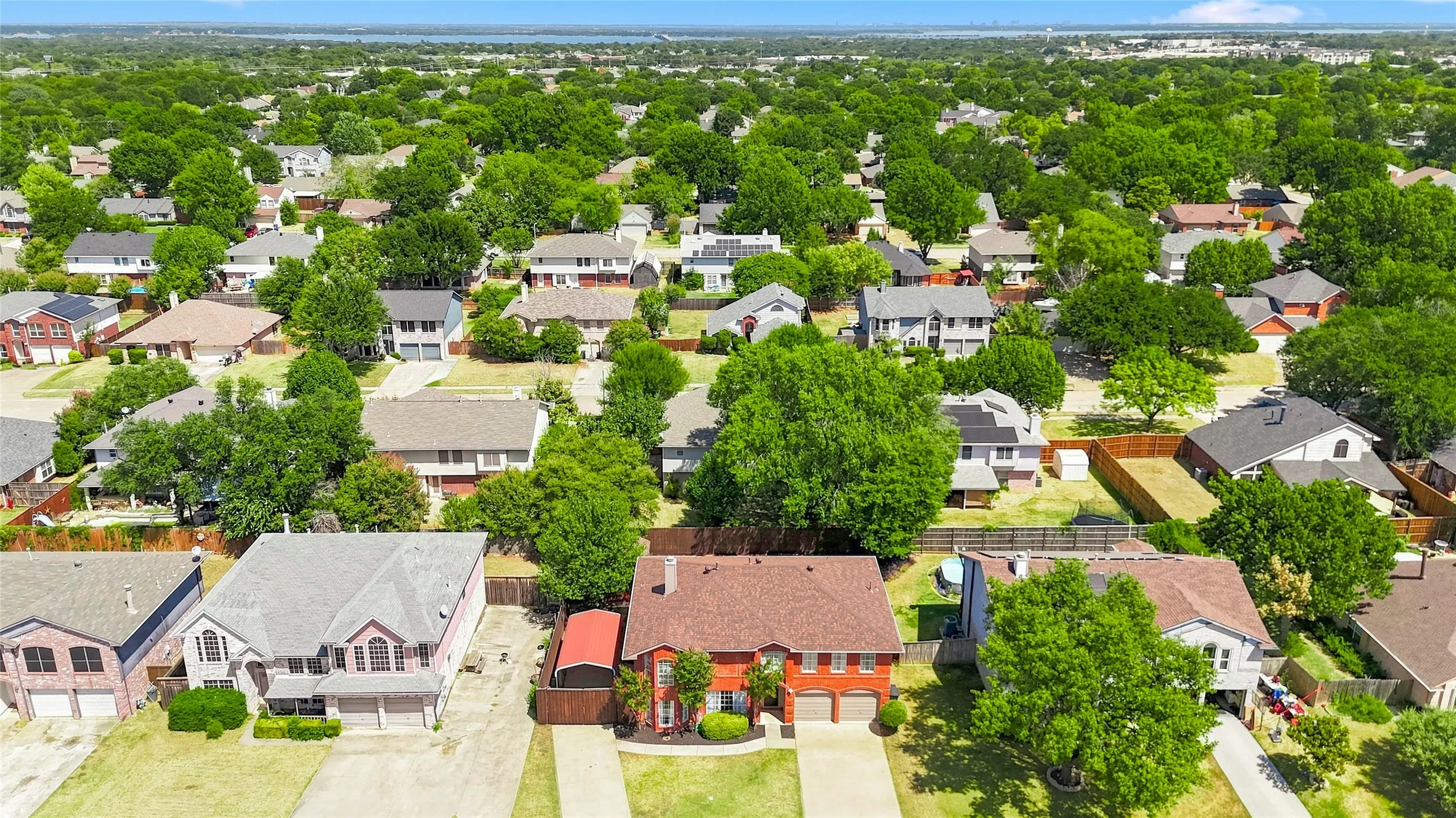 Aerial depiction of a residential area featuring multiple detached homes with varying architectural styles
