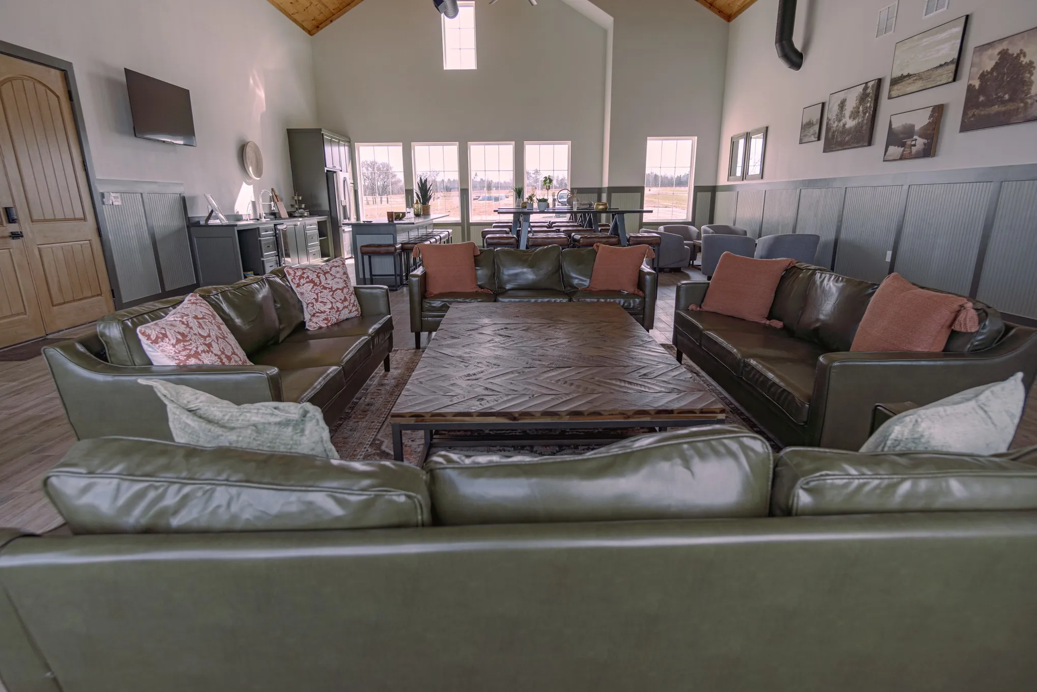 Living room featuring high vaulted ceiling, wooden ceiling, wood-type flooring, and ceiling fan