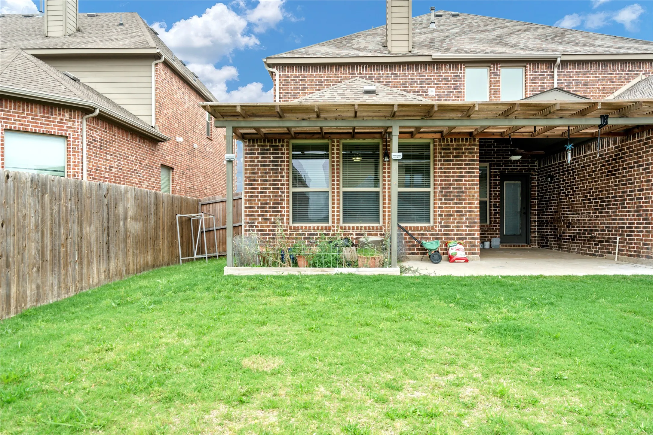 Expansive grass lawn with a wood privacy fence
