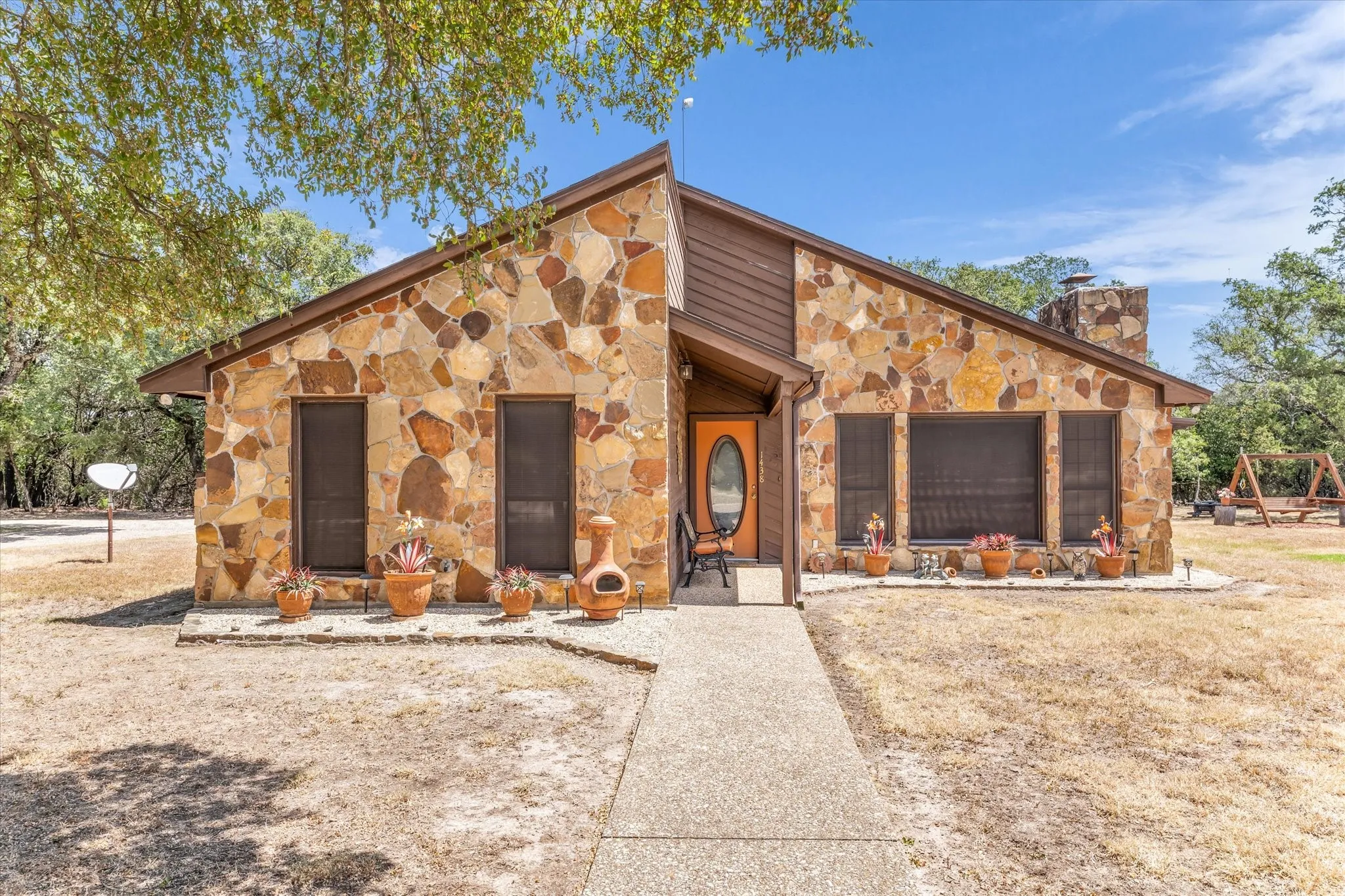 Stone veneer exterior with a prominent chimney