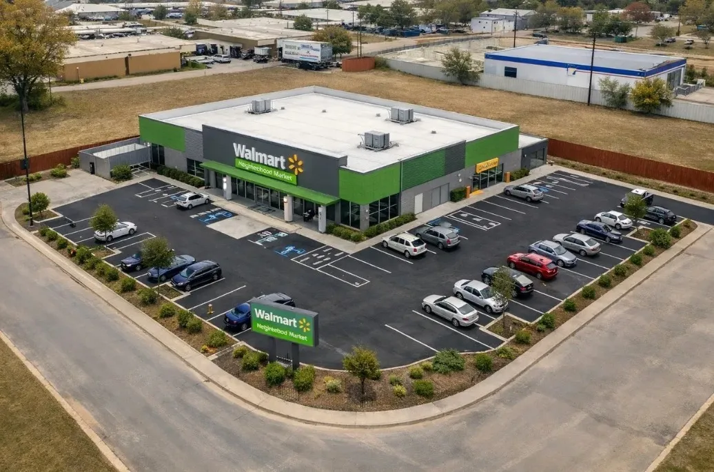 VIRTUAL CONCEPT RENDERING
Single-story commercial building with a grey and green facade, a flat roof, and a dedicated parking lot