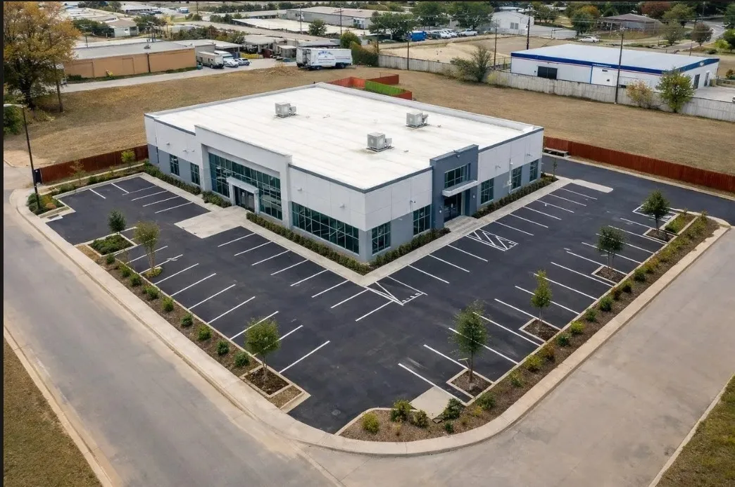 VIRTUAL CONCEPT RENDERING
Contemporary commercial building with a flat roof, large storefront windows, a paved parking area, and landscaped perimeter