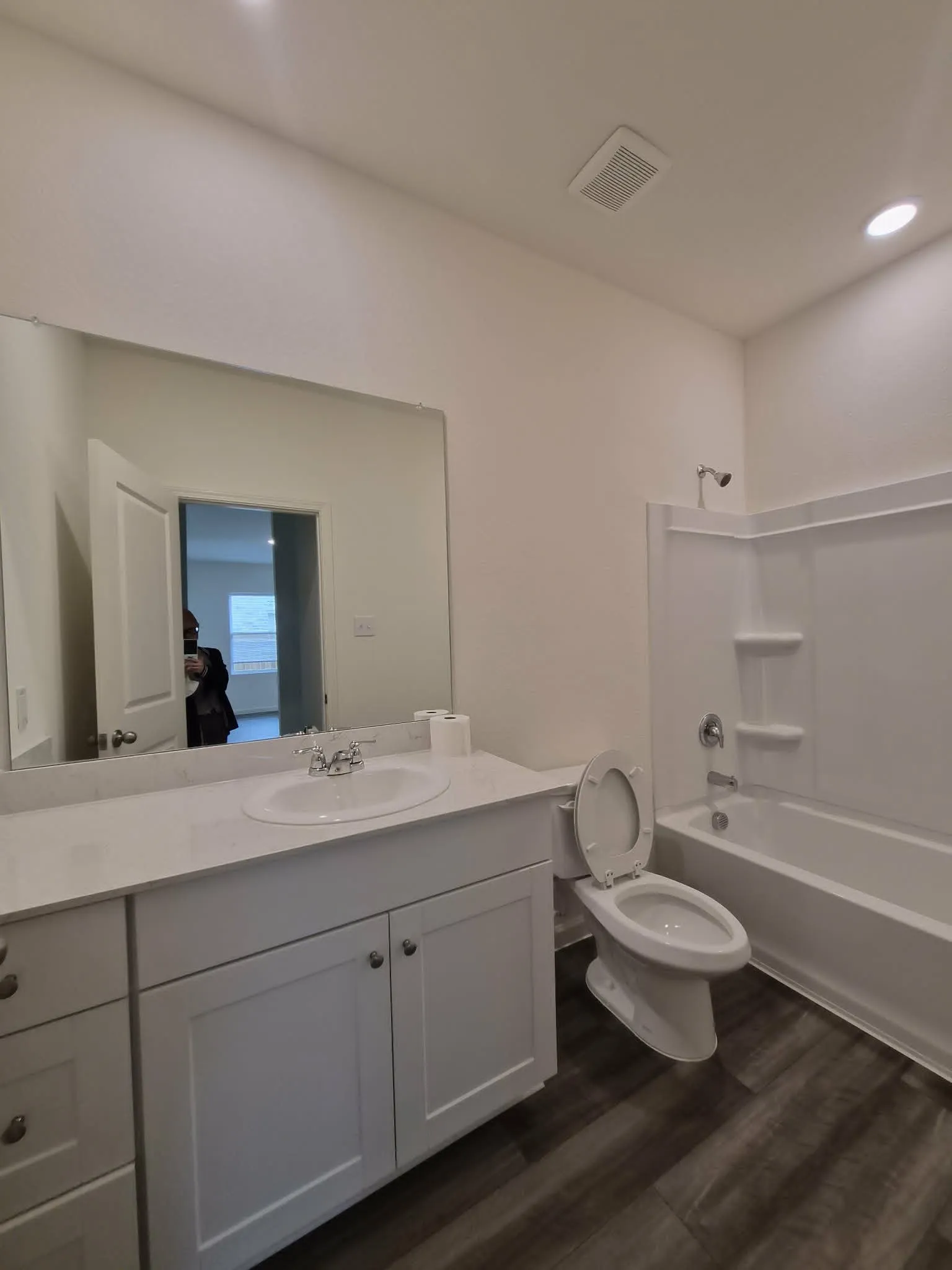 Vanity with an integrated sink, polished chrome faucet, and ample storage cabinetry