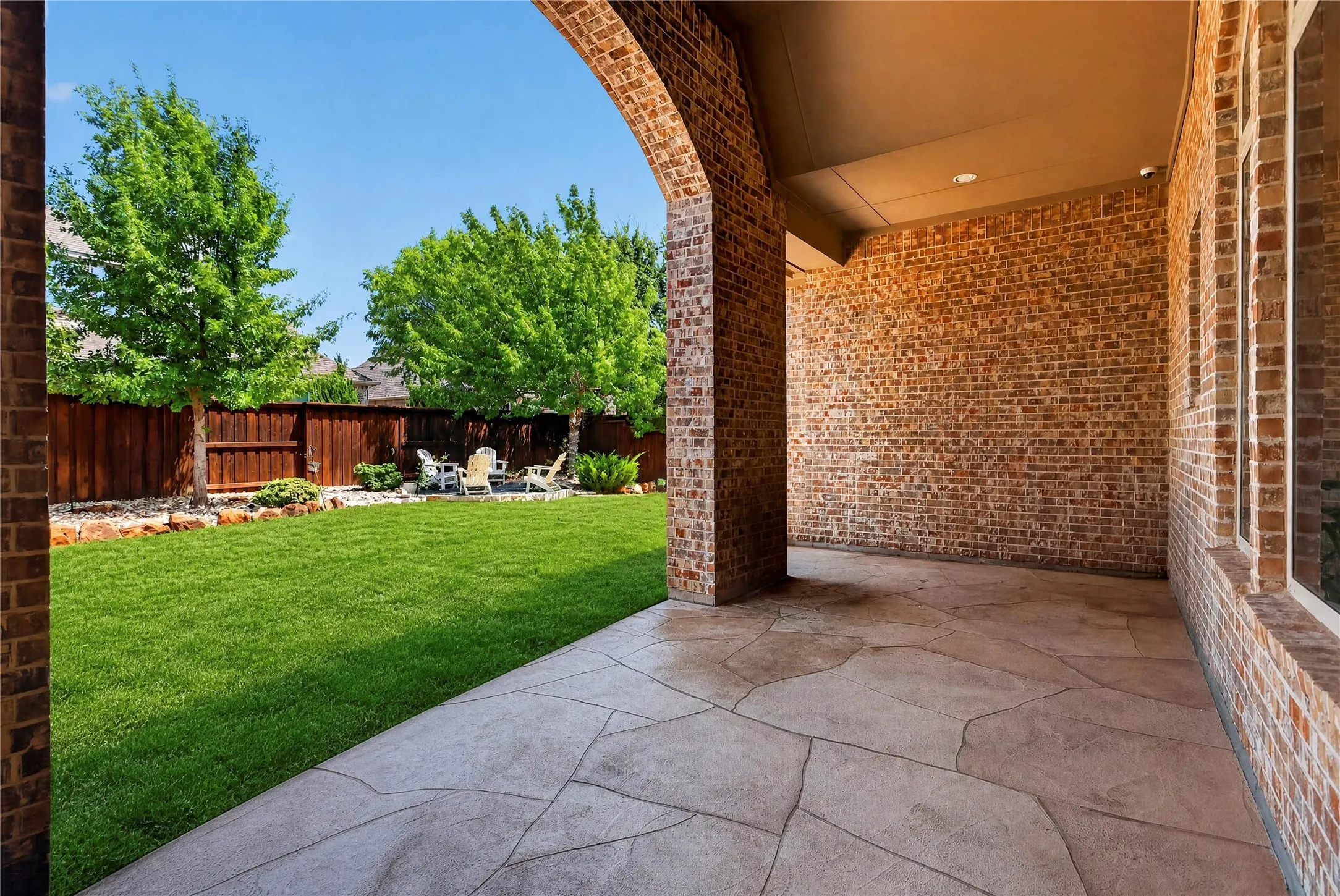 Covered patio overlooking back yard.