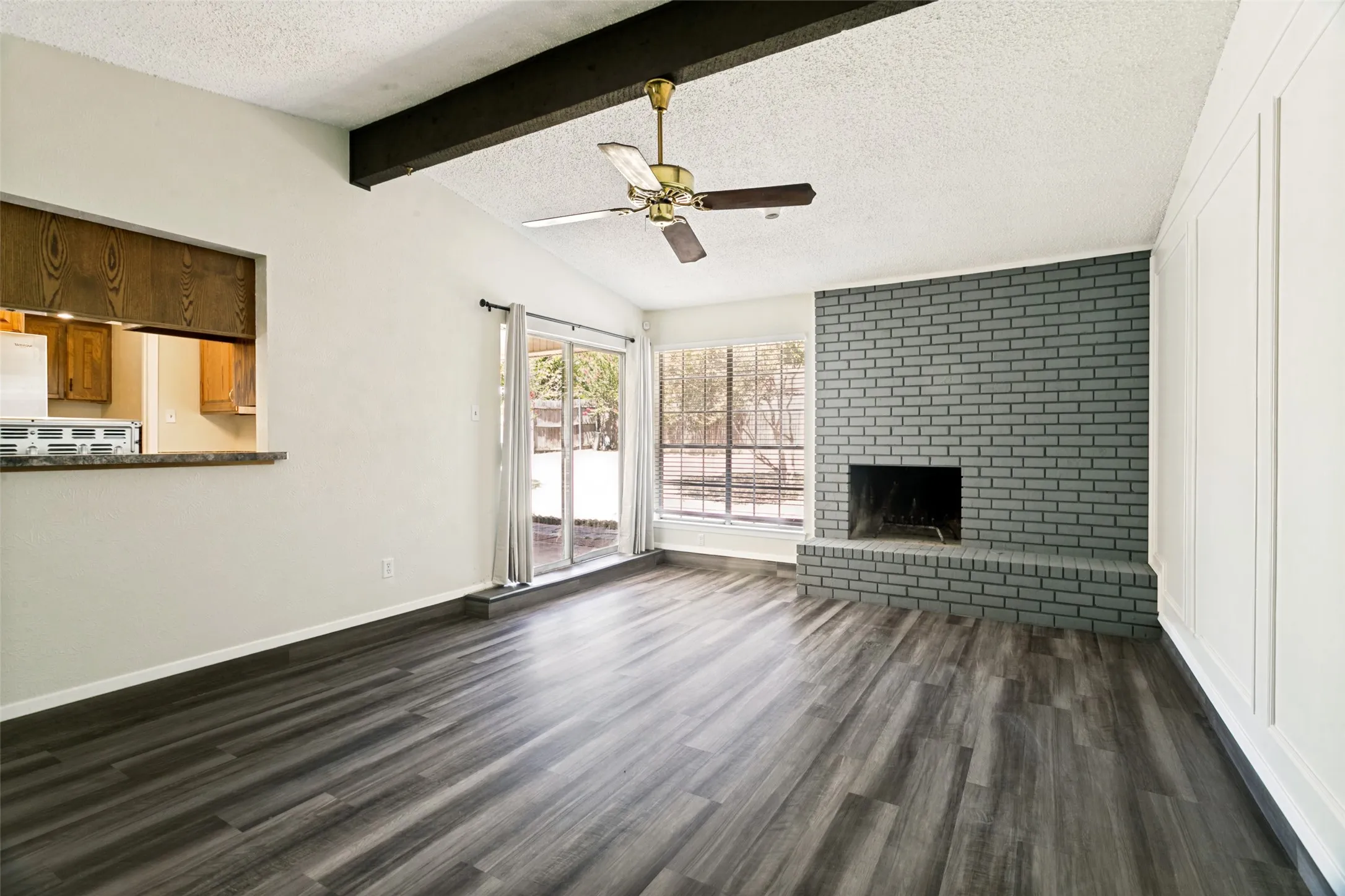 Gather and relax in the inviting living room featuring brand-new flooring and plenty of space for seating and entertaining. A fireplace adds warmth and character to this welcoming space.