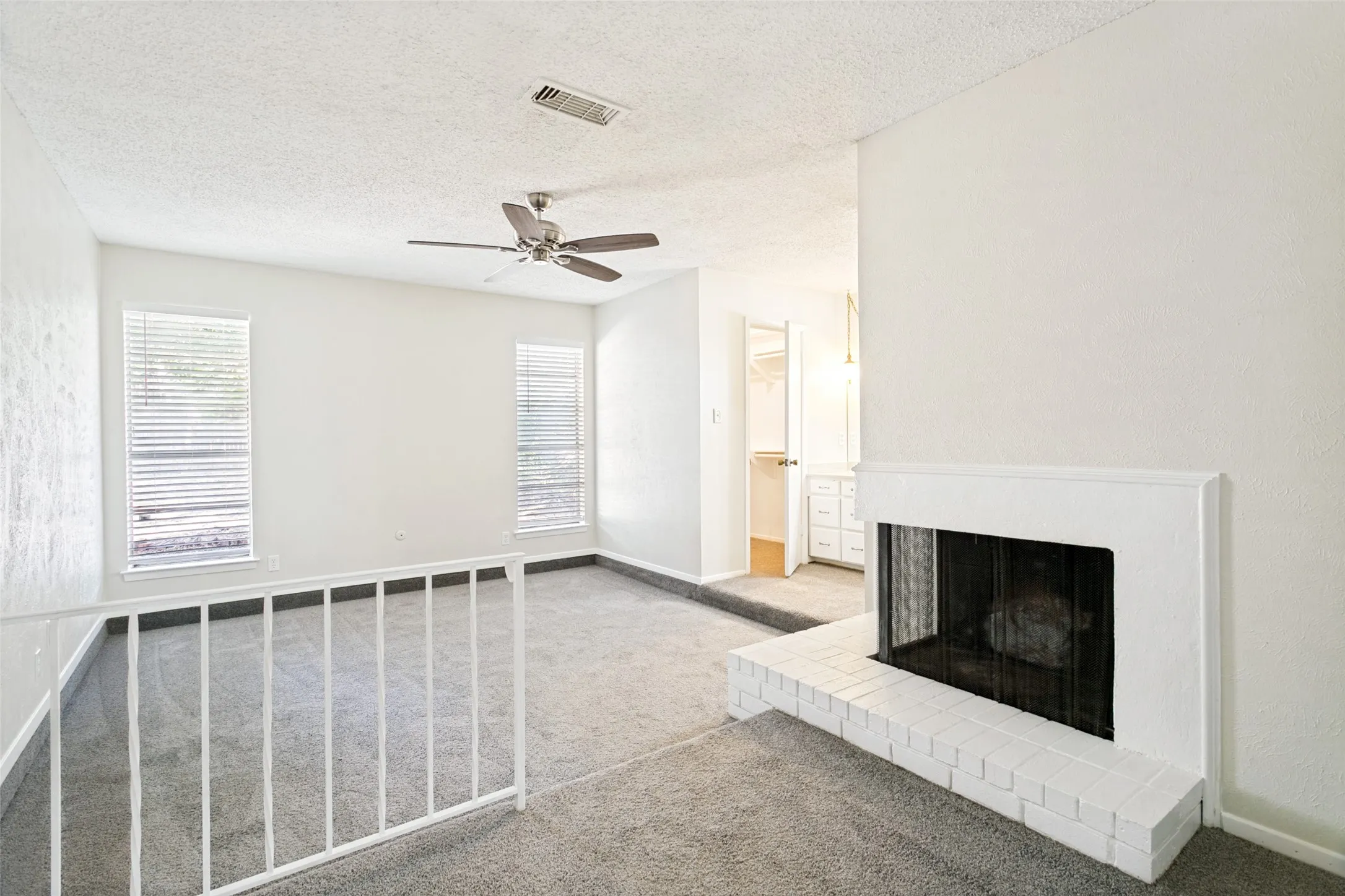 Relax and unwind in the spacious primary bedroom featuring brand-new carpet and a fireplace, plenty of room for comfortable furnishings. A peaceful retreat at the end of the day!