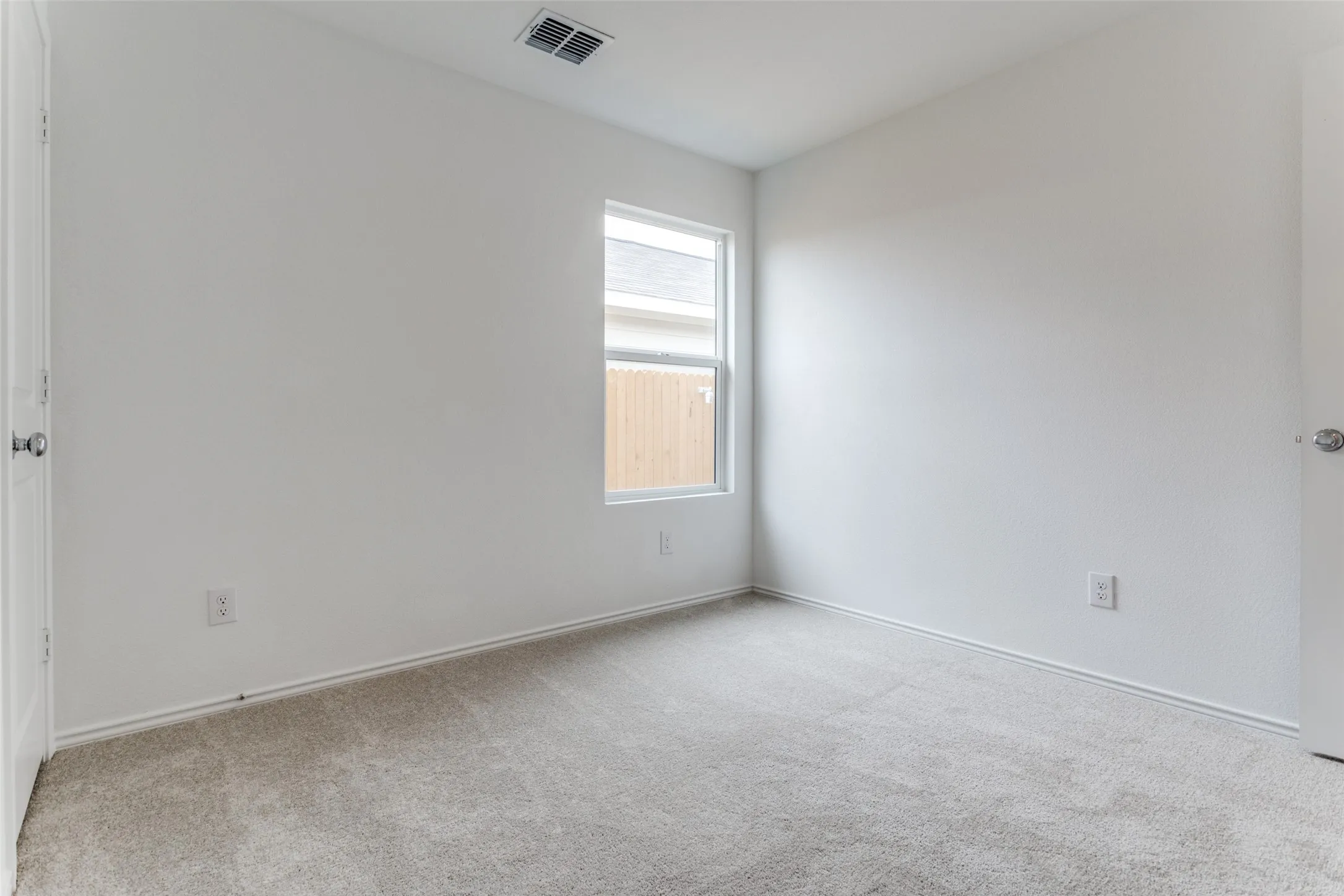 Carpeted empty room featuring plenty of natural light