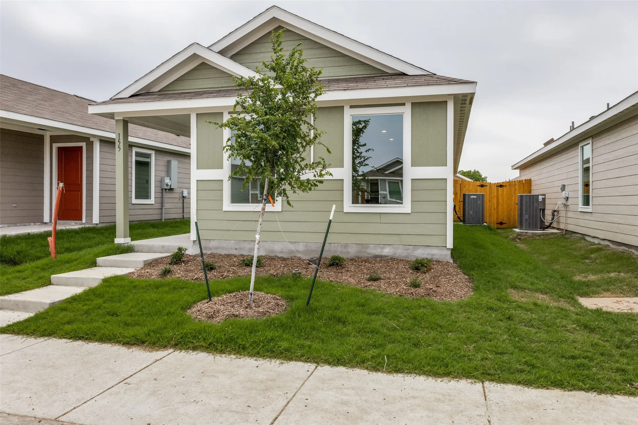 Bungalow featuring a front lawn and central AC unit