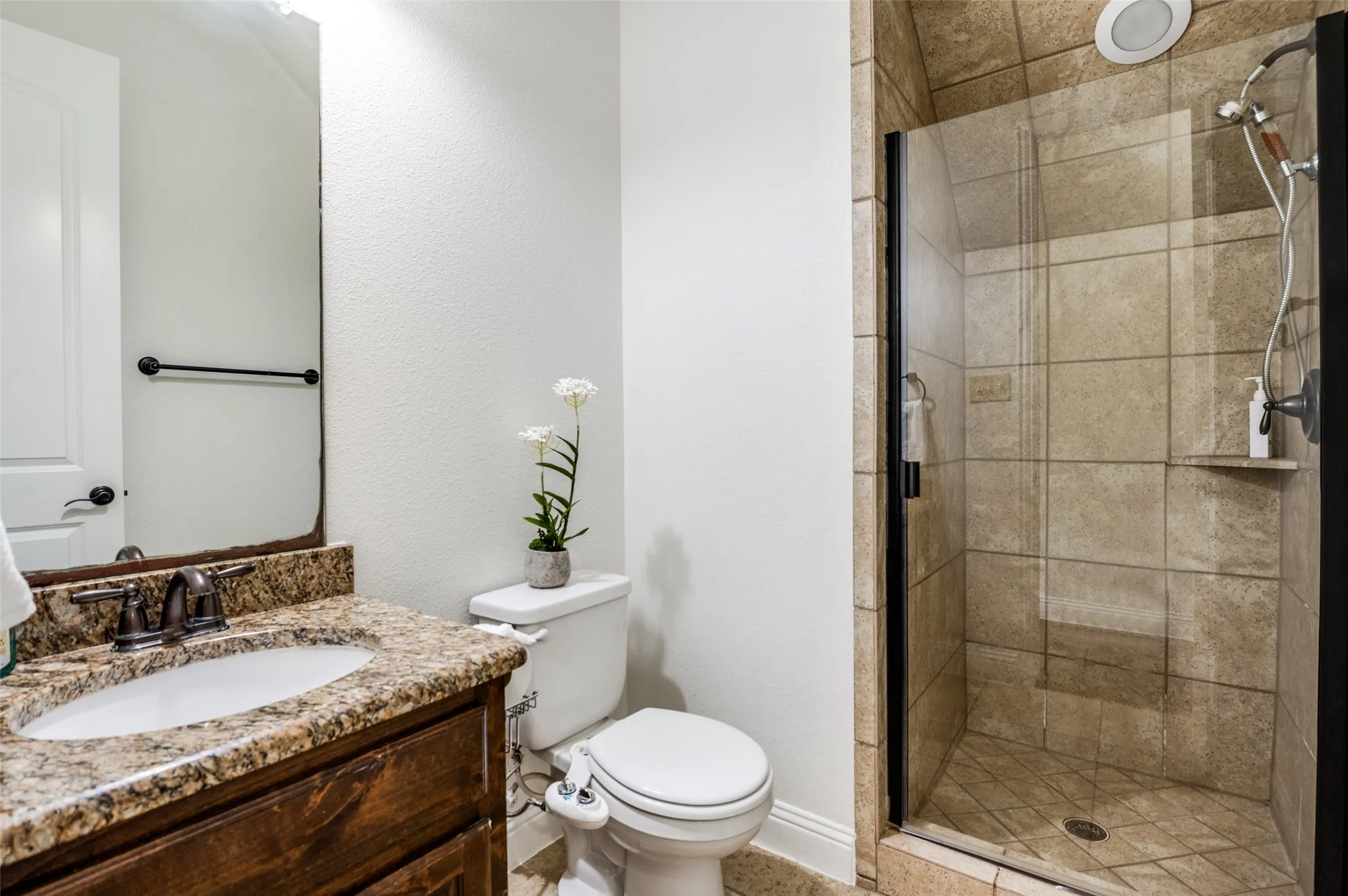 Wood-finish vanity with granite countertop and undermount sink