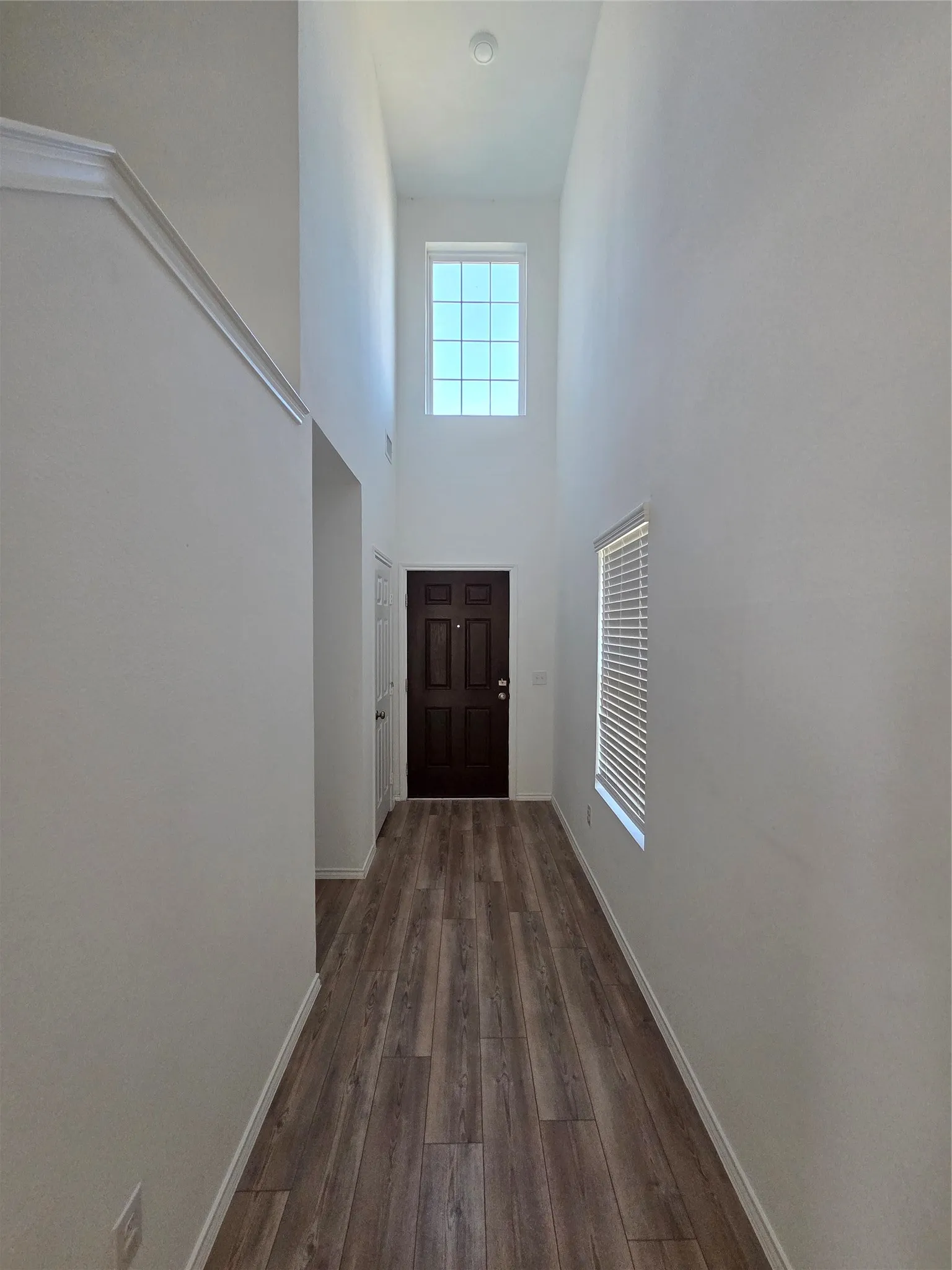 Two-story foyer with wood-finish flooring
