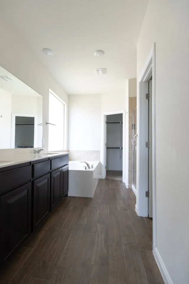 Dual vanity with dark wood-finish cabinetry and light-toned countertops