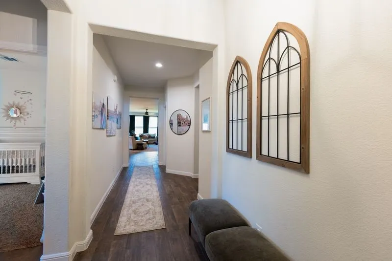 Hallway featuring wood-finish flooring, recessed lighting, and white baseboards