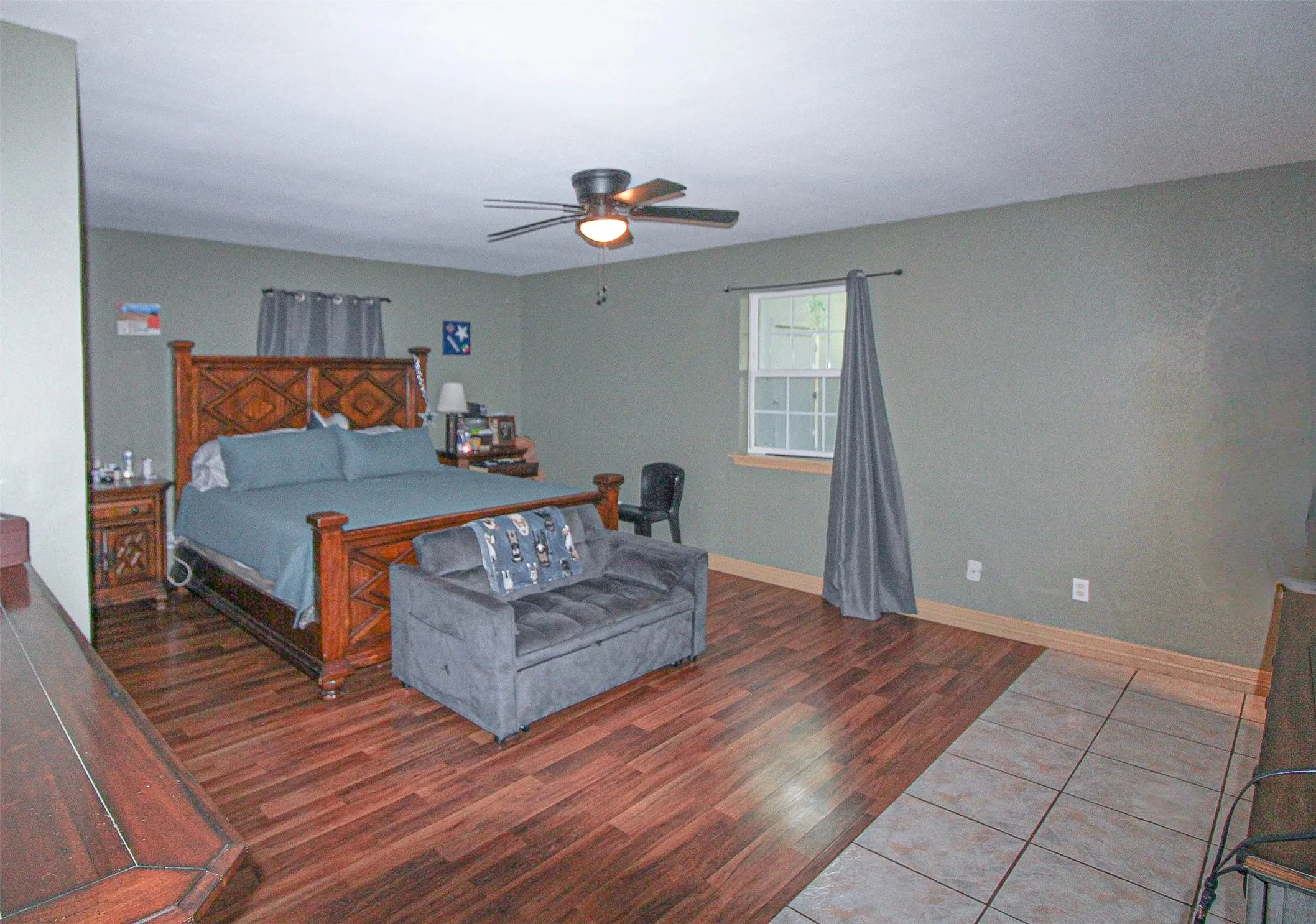 Recessed lighting, ceiling fan with integrated lighting, wood-finish flooring, single window, and a combination of tile flooring
