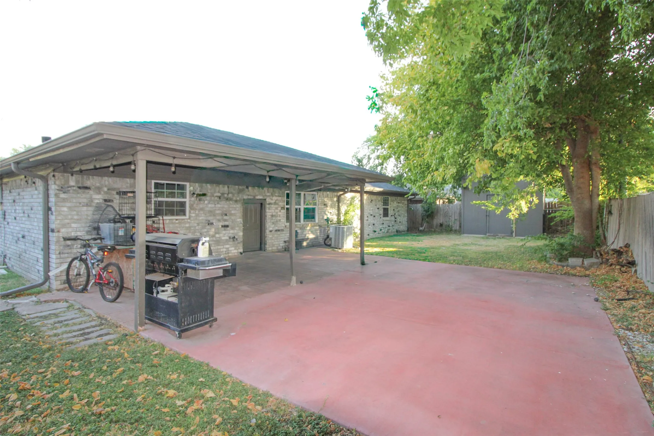 Expansive concrete patio with a covered section