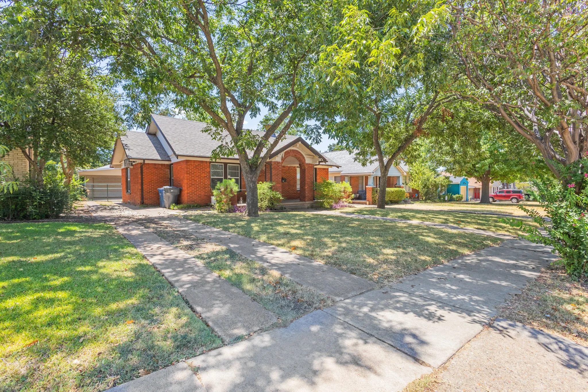 Brick exterior with a gabled roof and arched entry