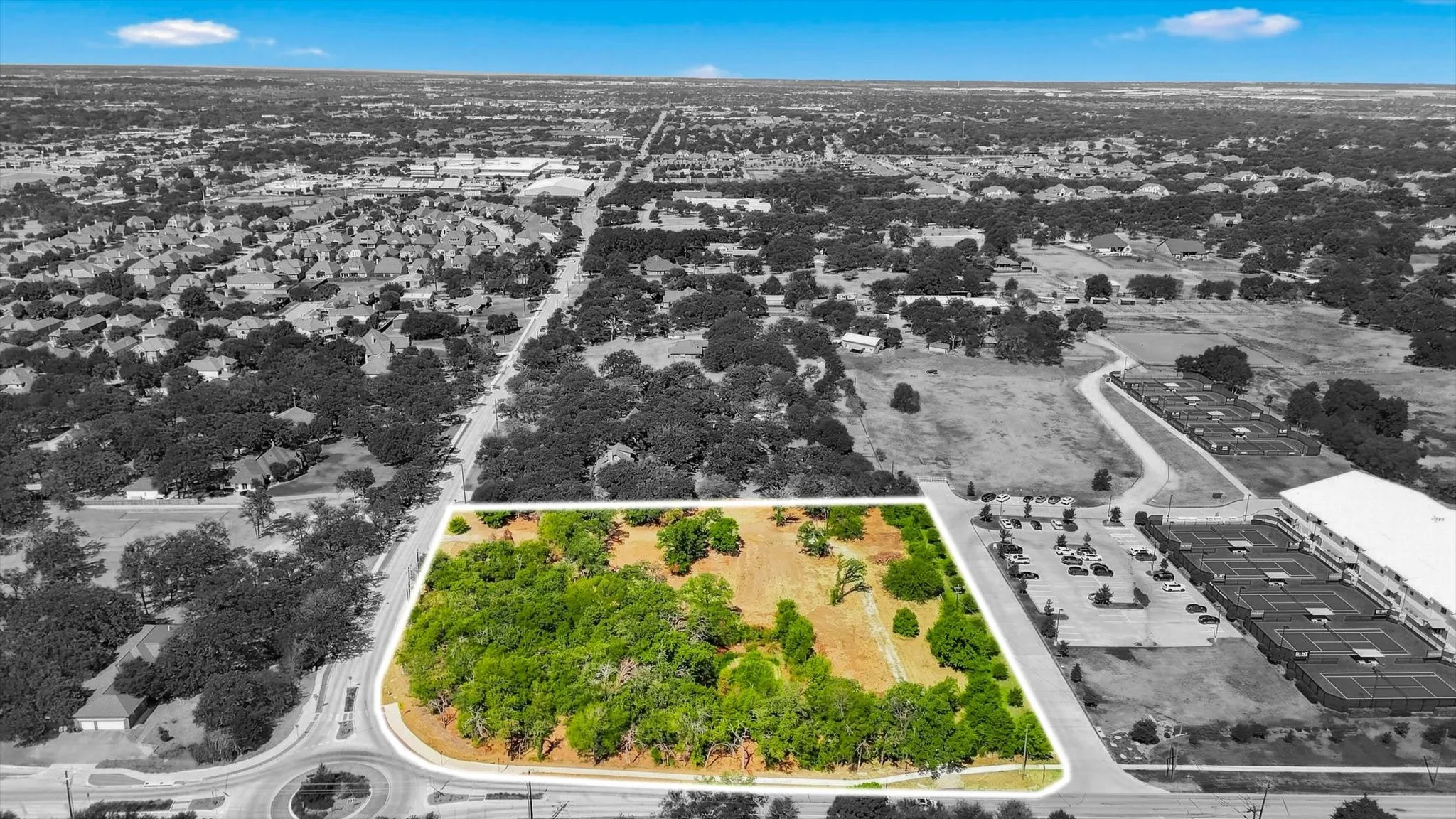 Expansive land parcel featuring natural tree coverage and a clear boundary outline