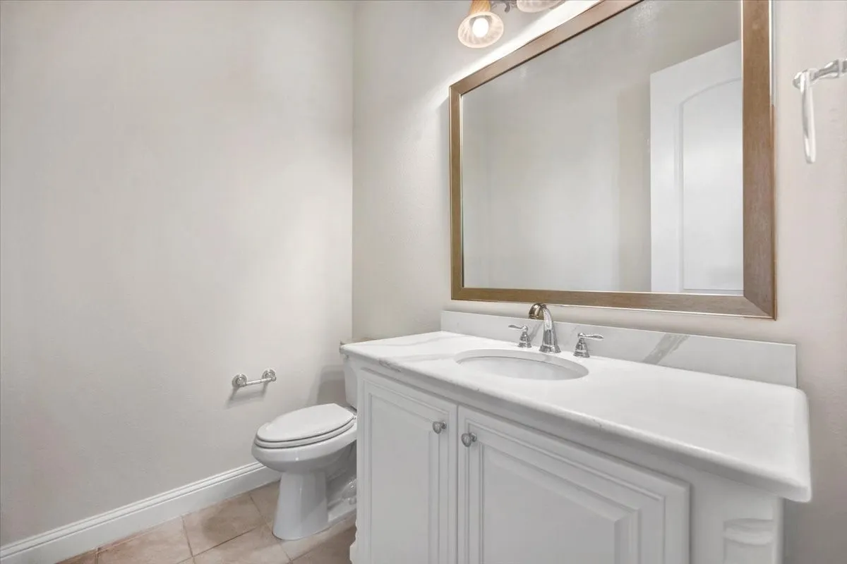 Guest 1/2 bath near game room & kitchen