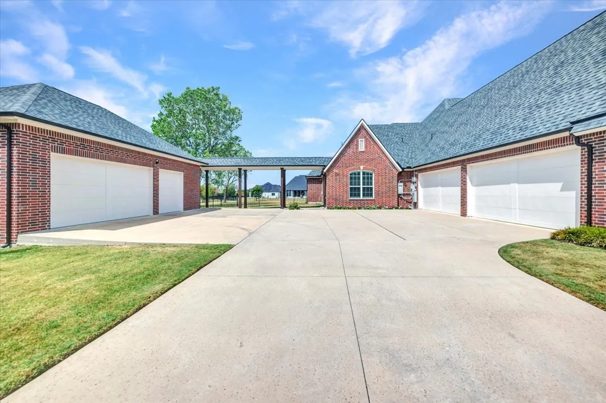 4 car attached garage & 3 car additional garage attached with walkway.  Attic is floored and ready for finish out if new owner wishes to convert to guest quarters or rec room
