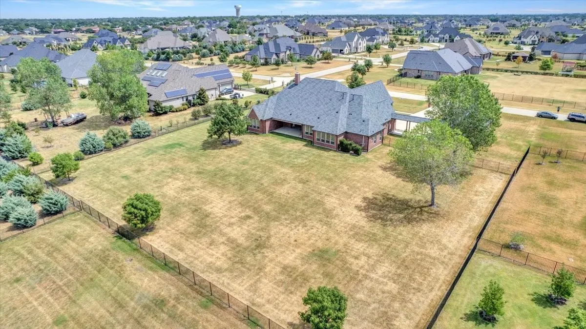 Large fenced back yard with trees
