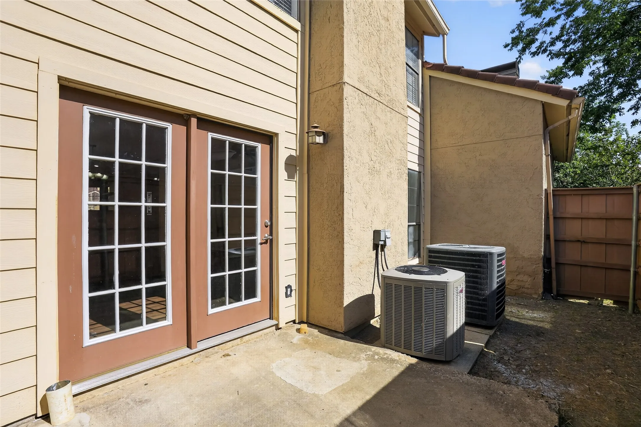 Patio with concrete surface, double glass-paned doors, and exterior siding