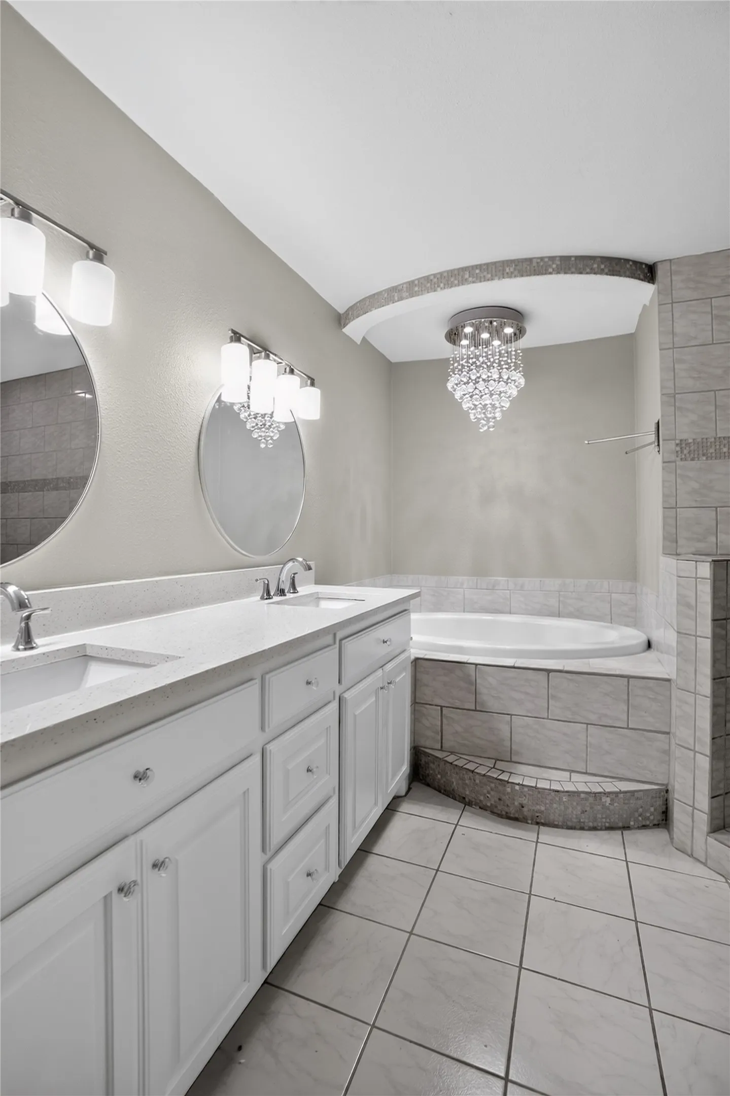 Dual vanity with white cabinetry and integrated sinks
