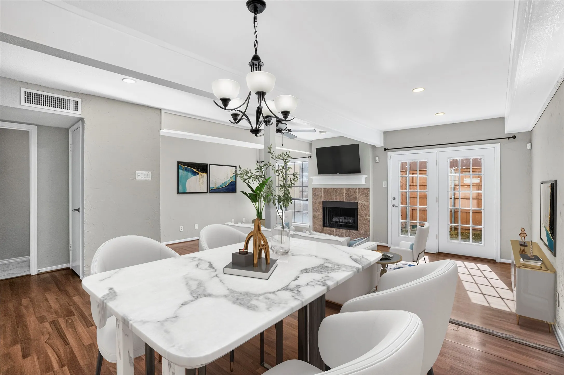 Dining area featuring wood-finish flooring, a chandelier, and crown​​‌​​​​‌​​‌‌​‌‌​​​‌‌​‌​‌​‌​​​‌​​ molding