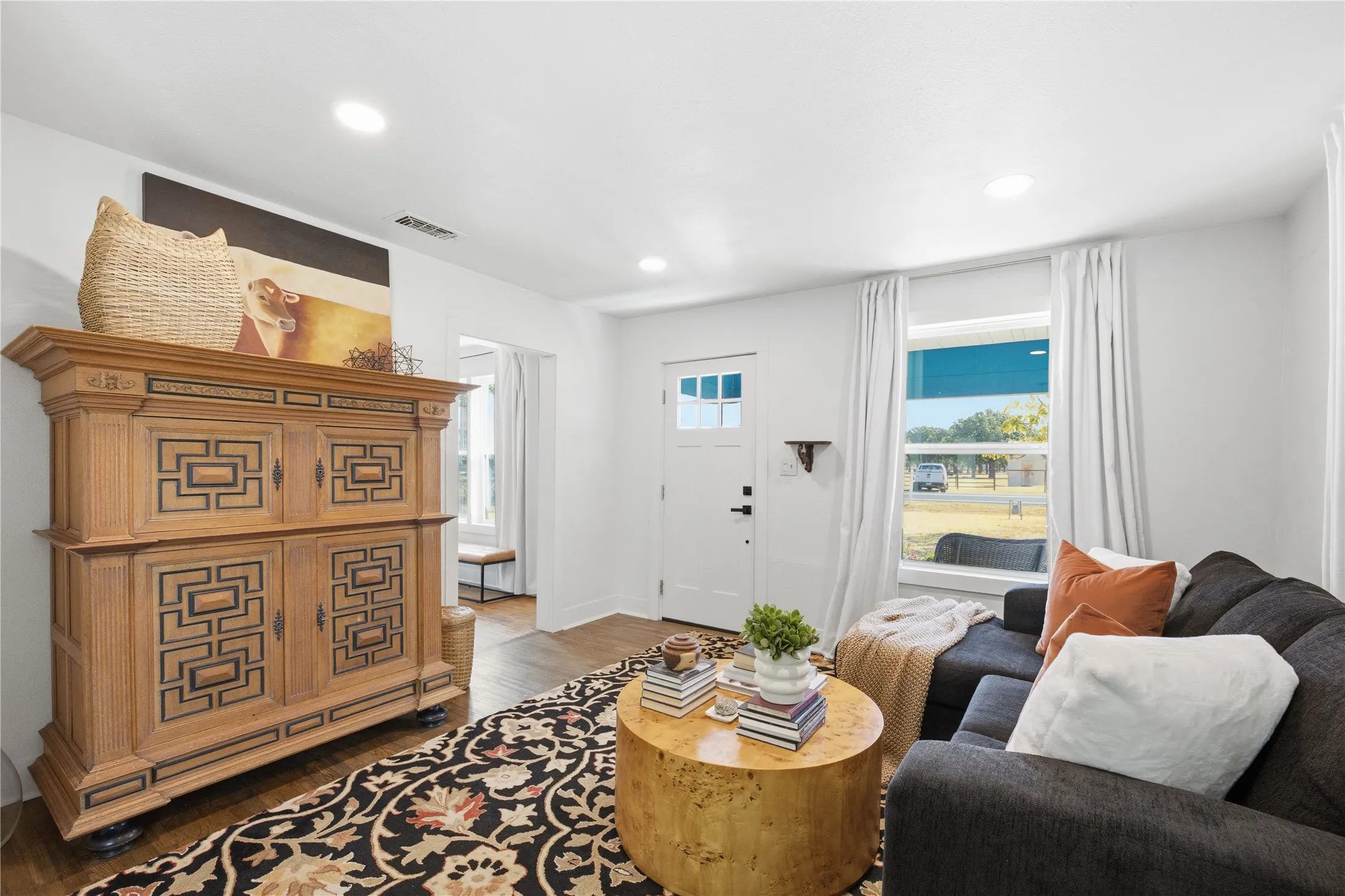 Recessed lighting, wood-finish flooring, and white walls