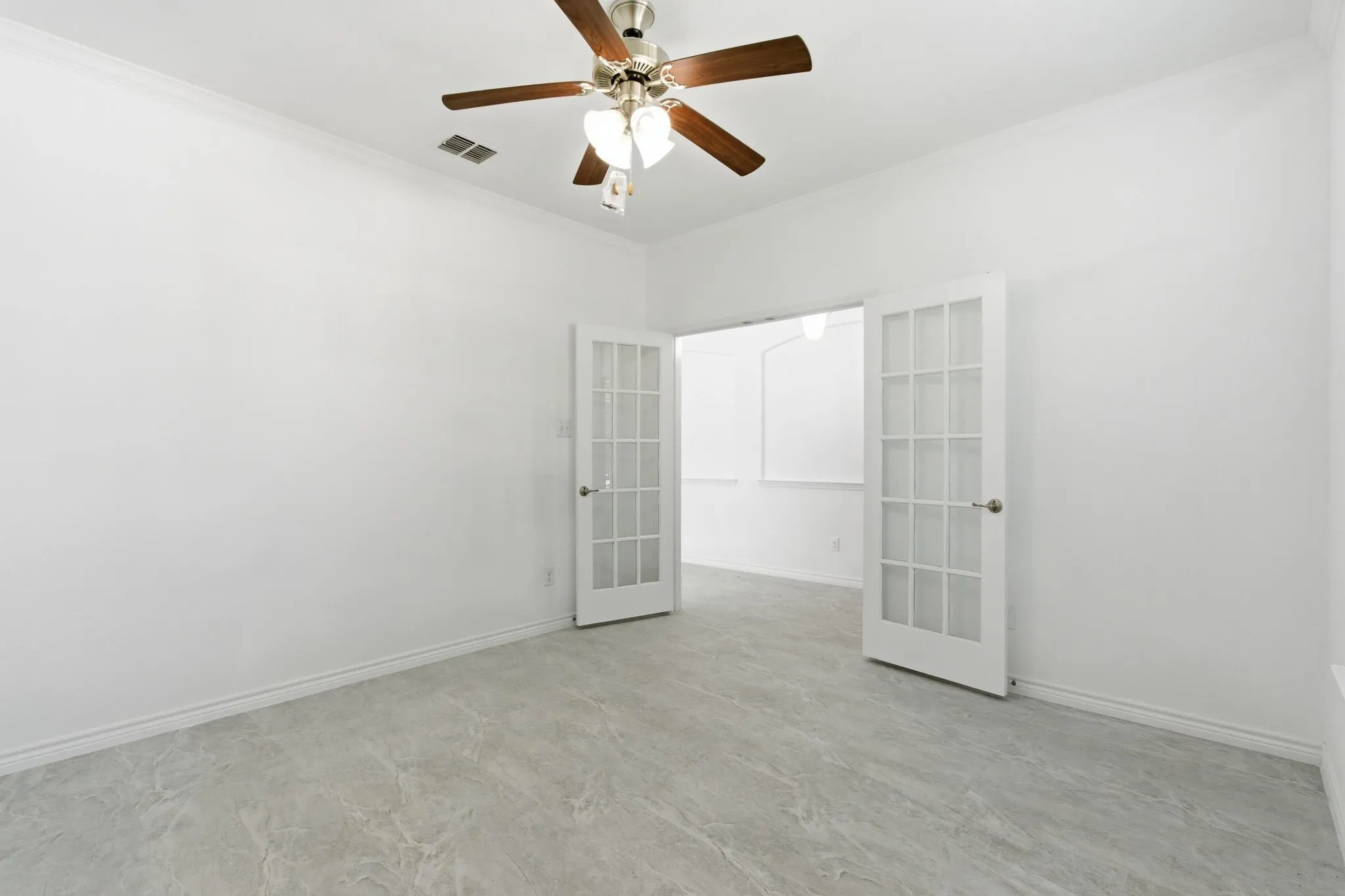 Ceiling fan with light fixture, crown molding, French doors, and tile flooring