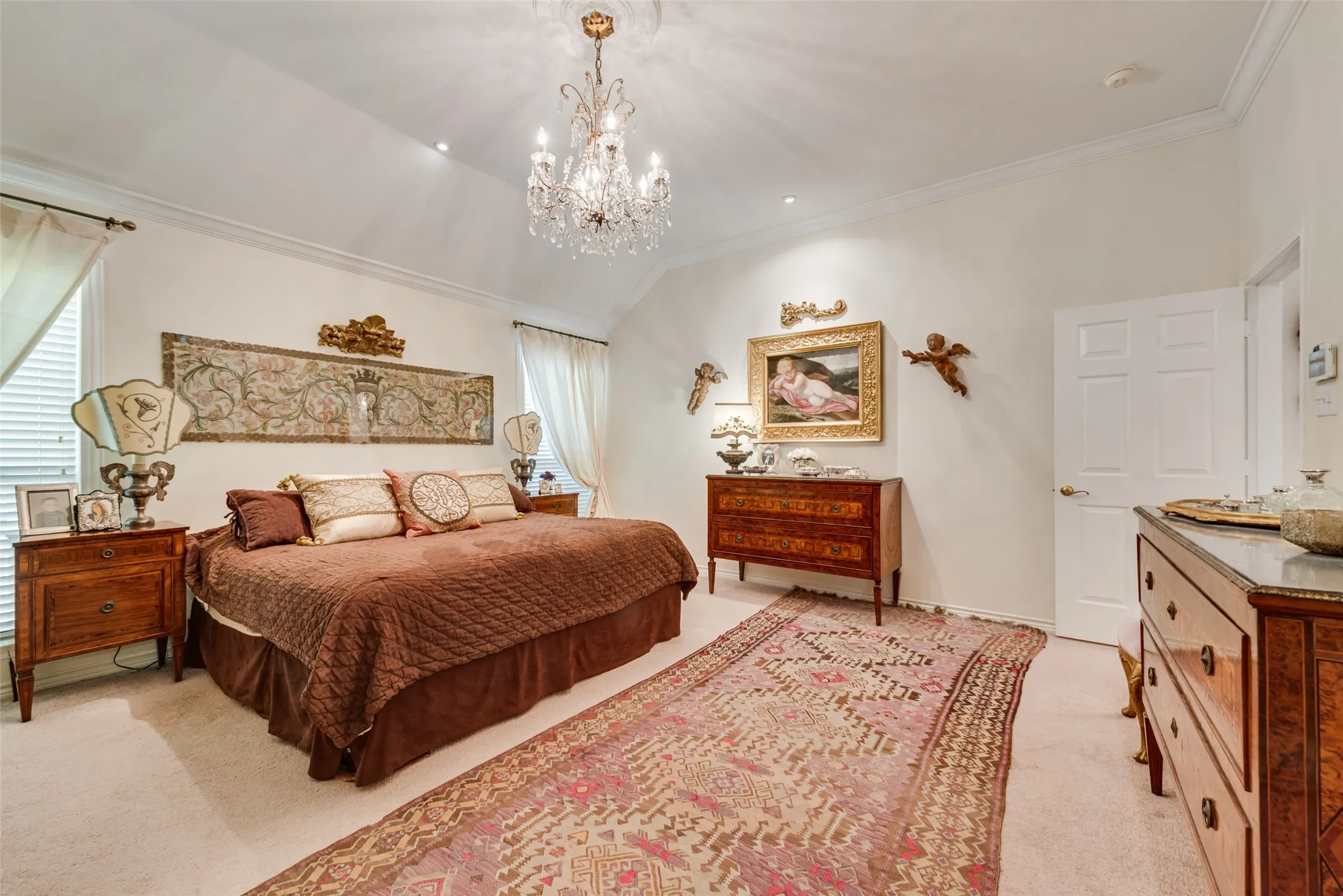 Vaulted ceiling with an recessed lighting, crown molding, and light-colored carpeting
