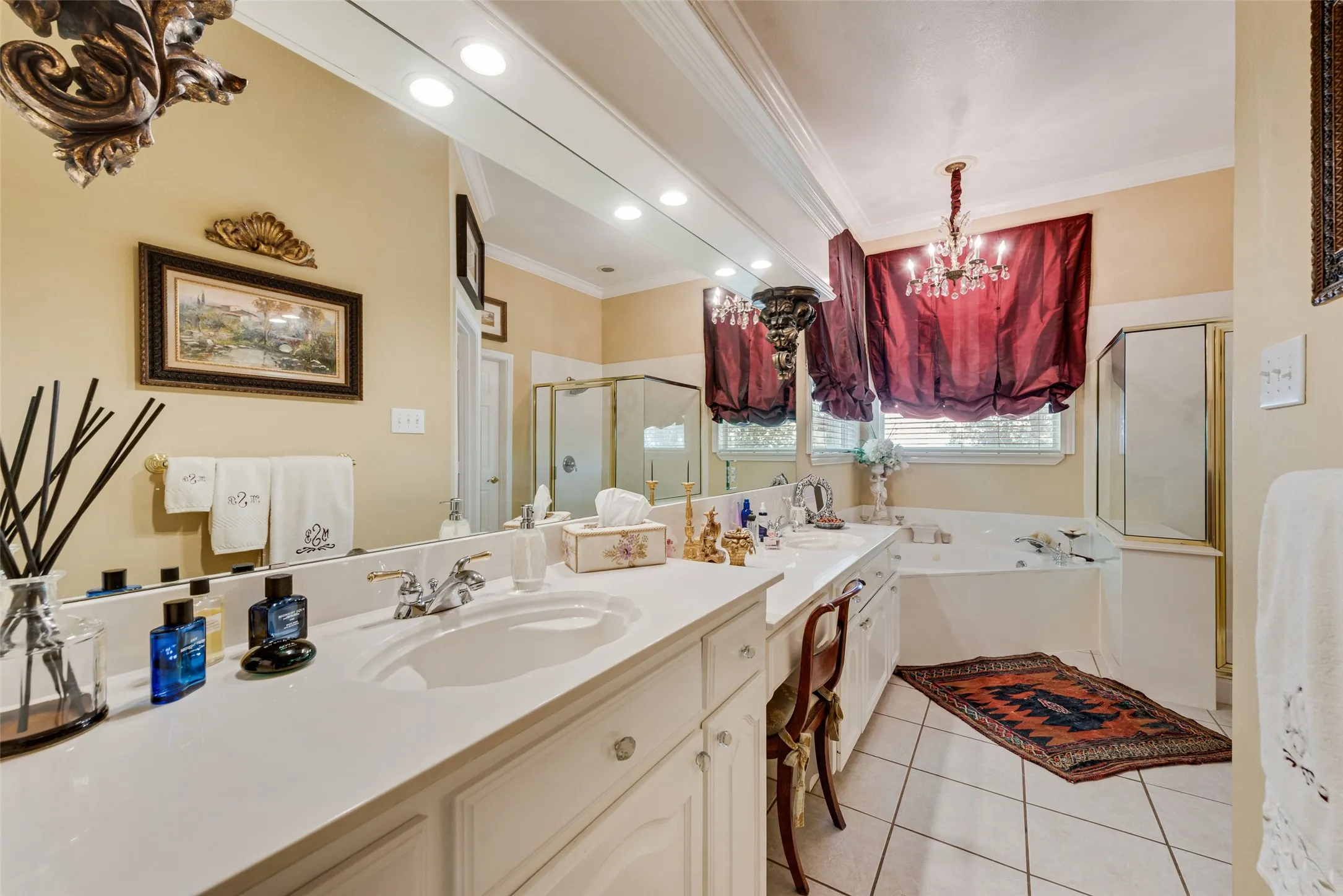 Dual vanity with undermount sinks and extensive countertop space, complemented by a large wall-mounted mirror