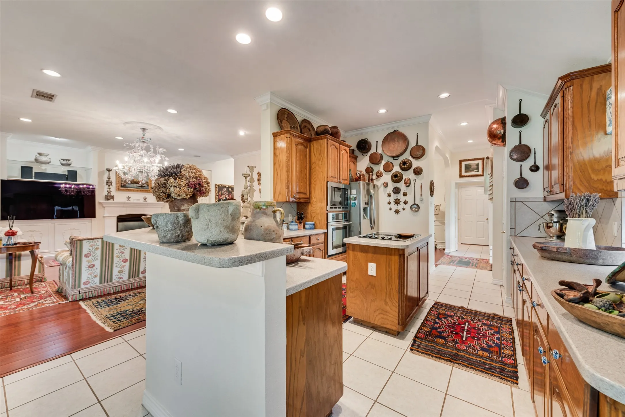 Kitchen with wood cabinetry, light-toned countertops, and tile flooring
