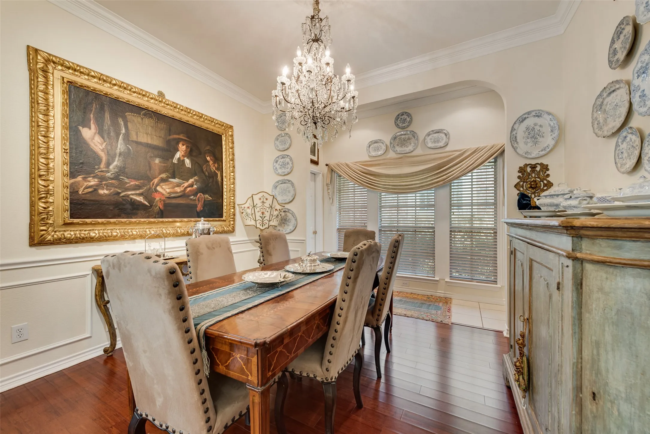 Hardwood flooring, decorative wall molding, and a crystal chandelier