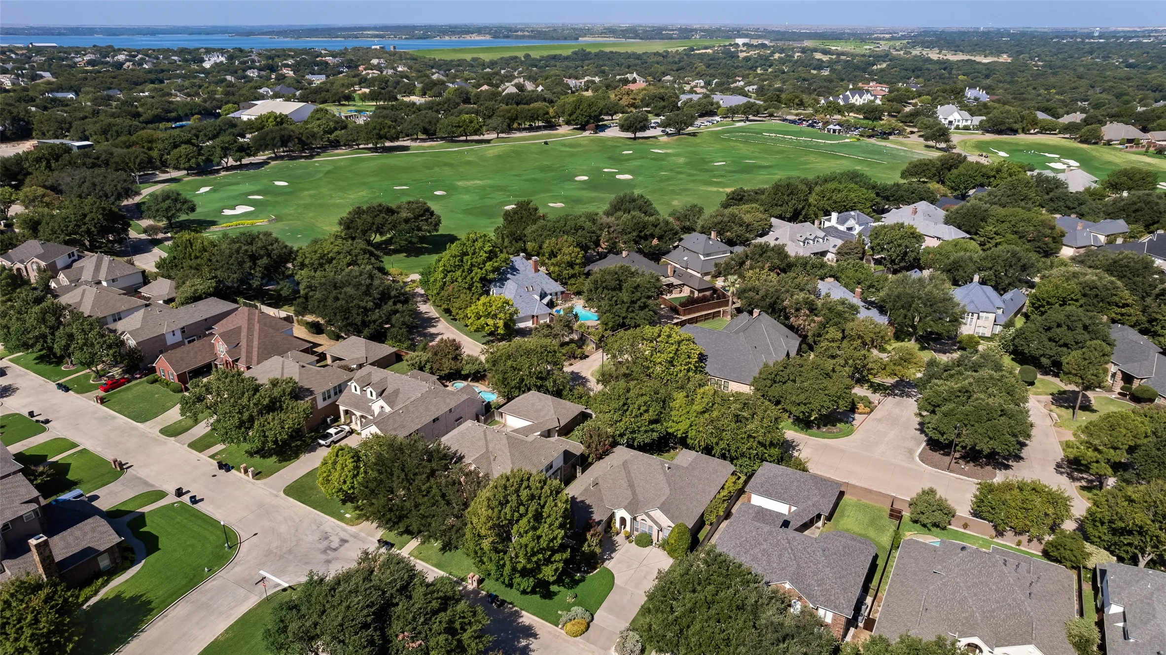 Residential area featuring mature trees and a golf course